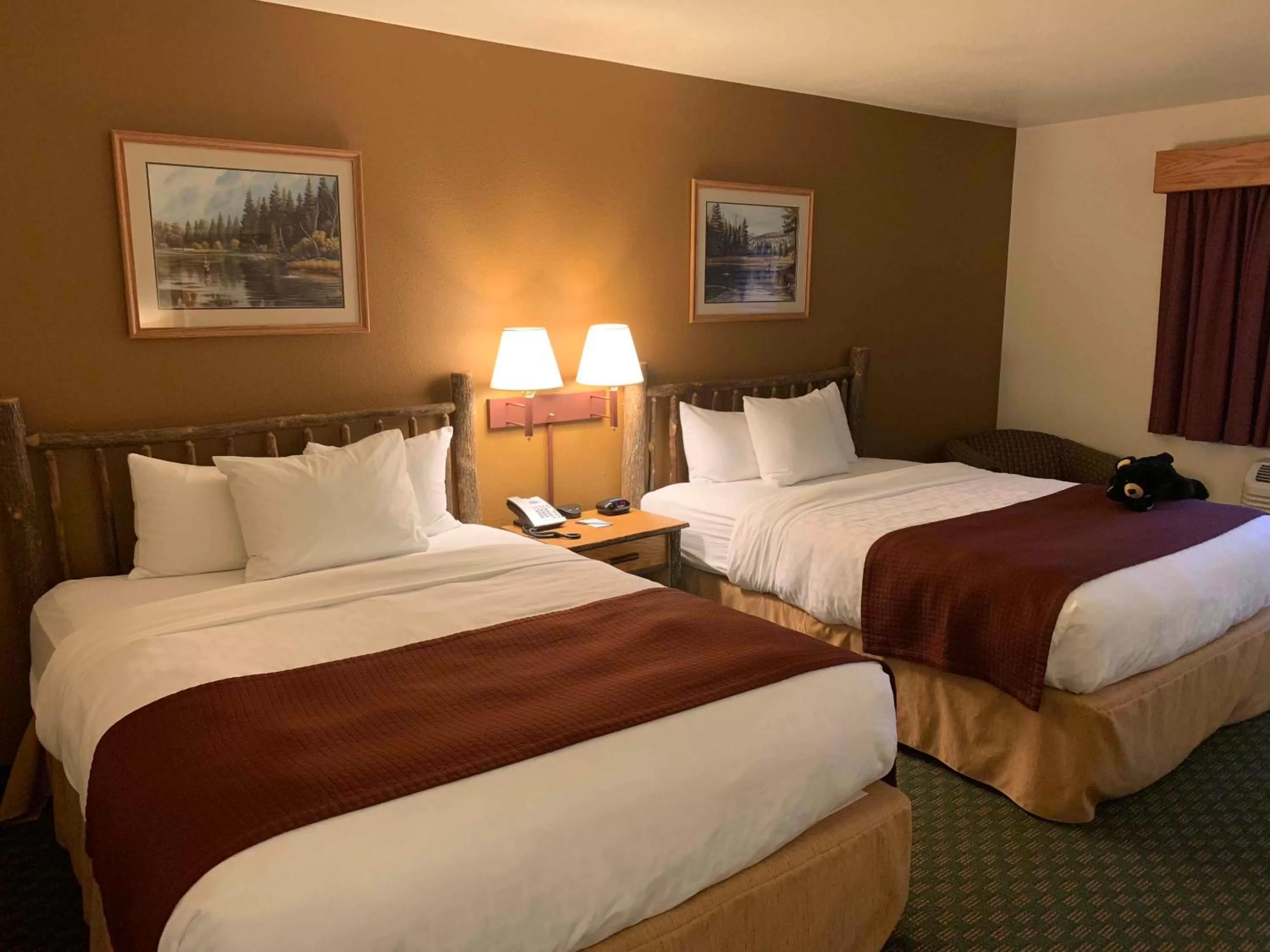 Bed in AmericInn by Wyndham Cody