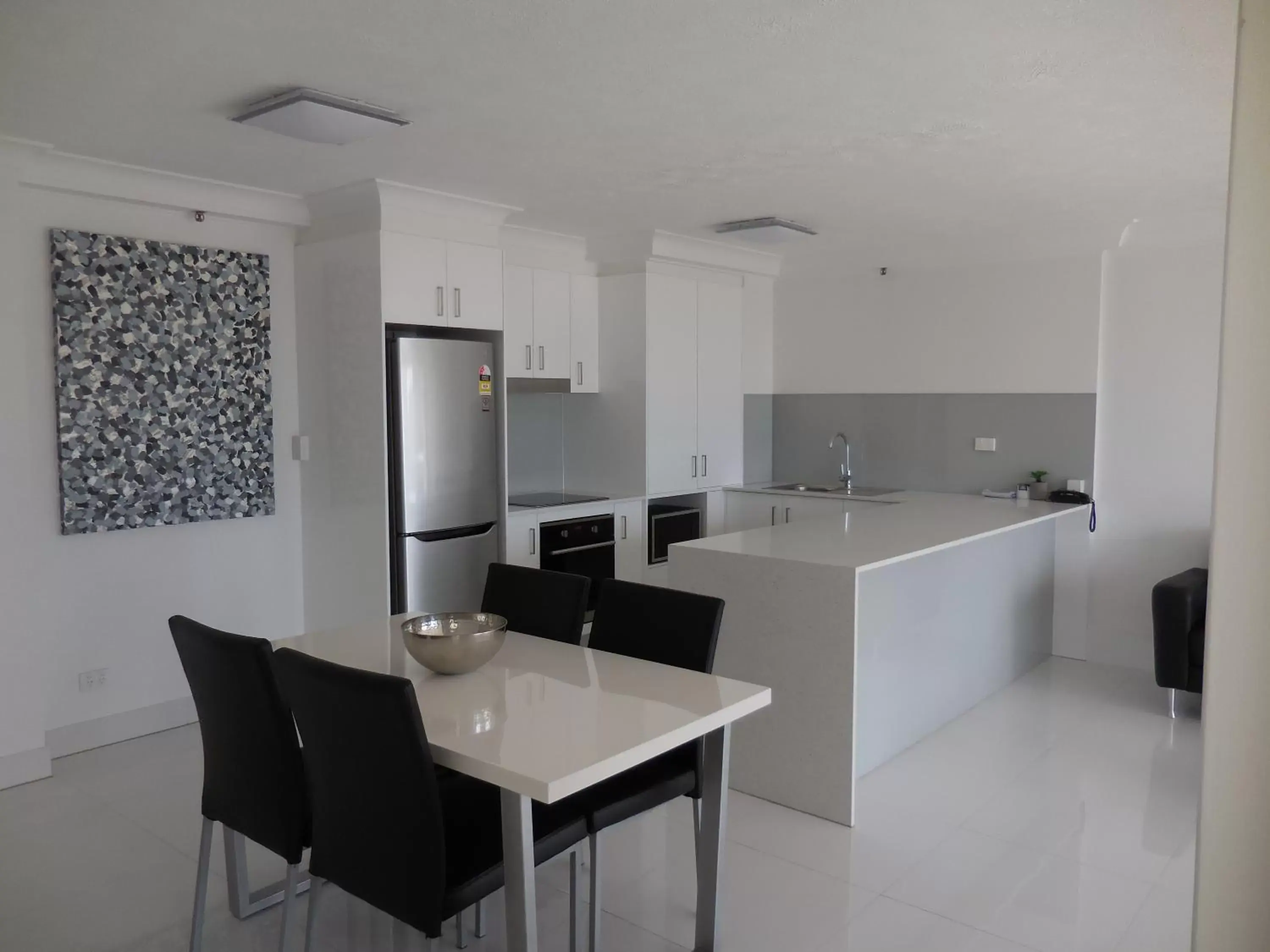 Living room, Kitchen/Kitchenette in Surfers Century Oceanside Apartments