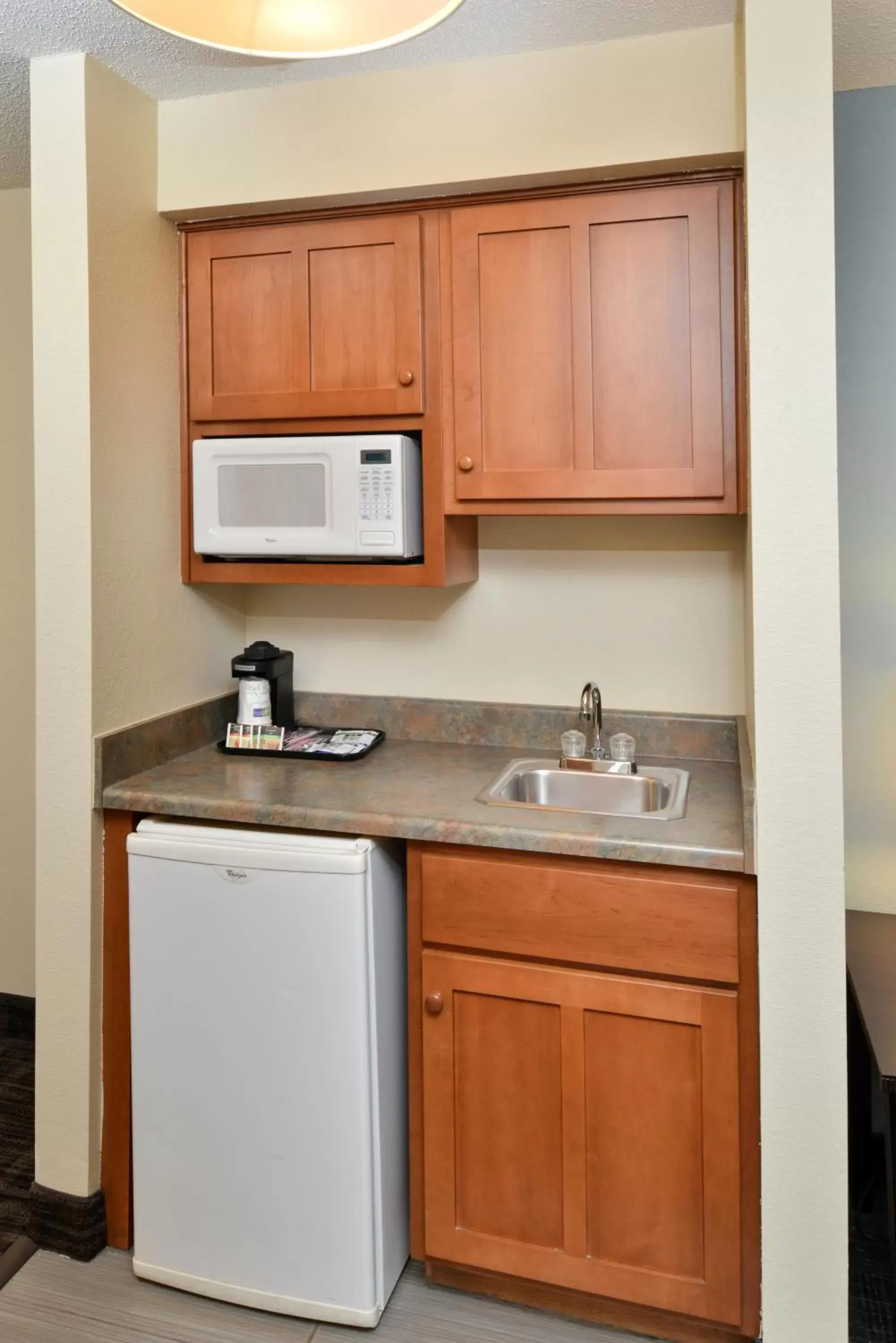 Bedroom, Kitchen/Kitchenette in Holiday Inn Express Hotel & Suites-Saint Joseph, an IHG Hotel