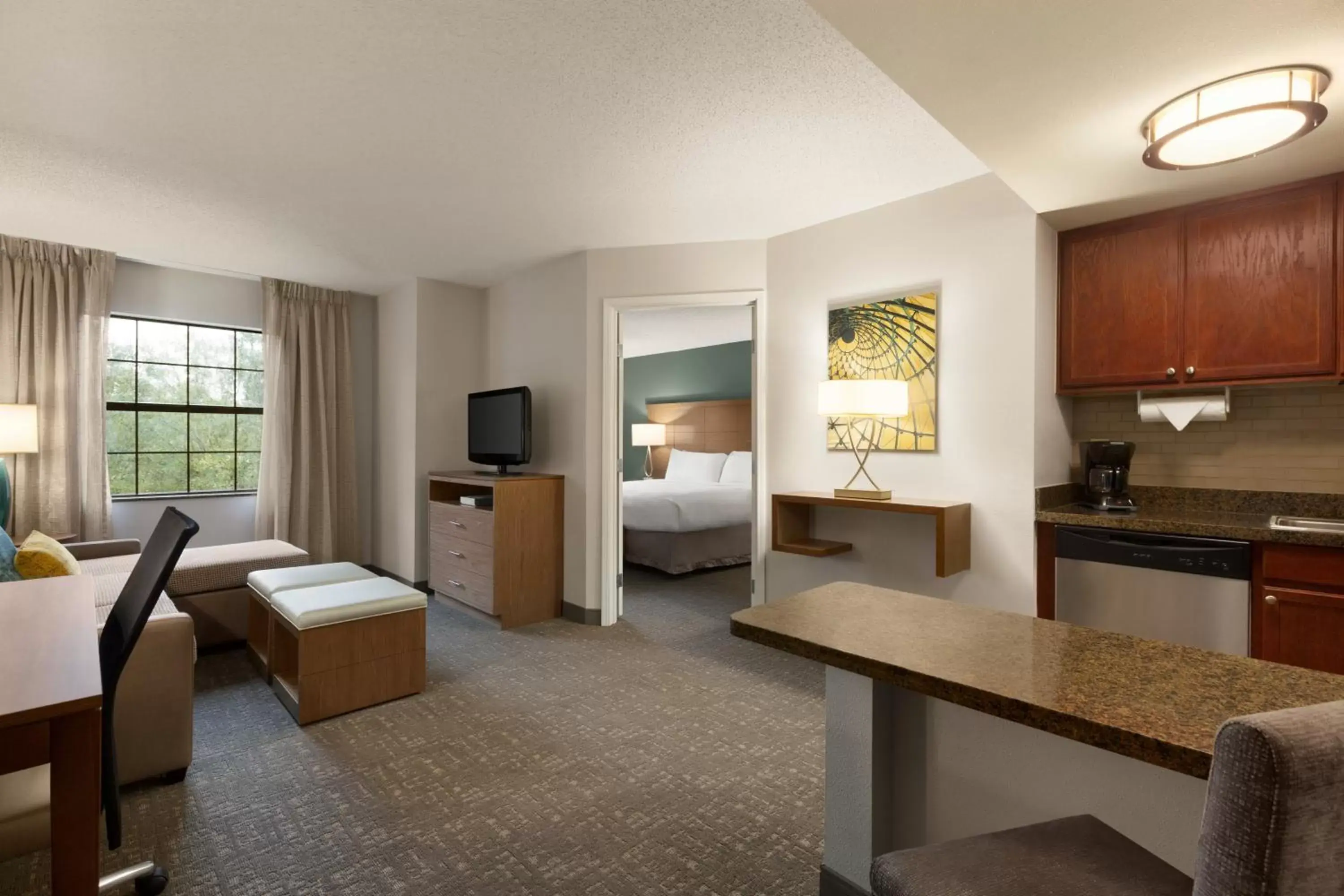 Bedroom, Seating Area in Staybridge Suites Tampa East- Brandon, an IHG Hotel