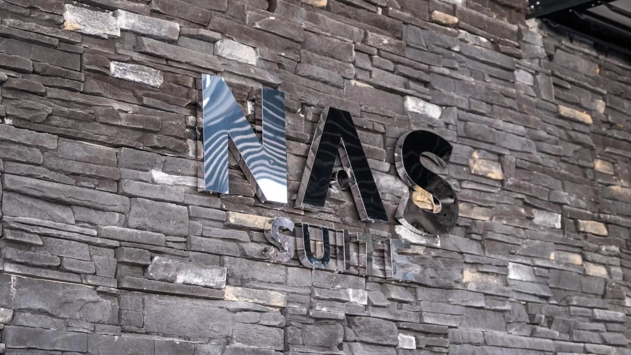 Property logo or sign in Nas Suite