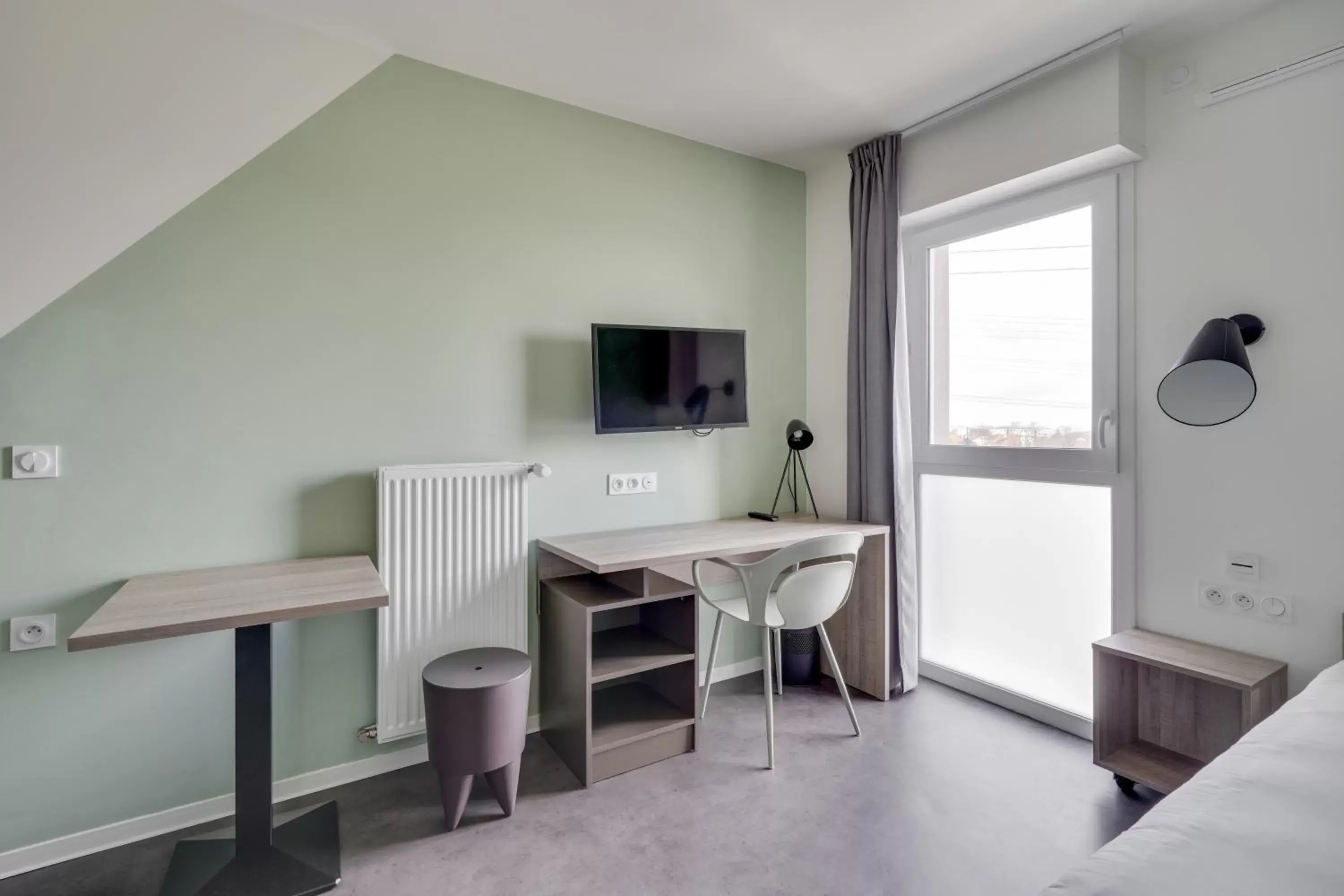 Bedroom, TV/Entertainment Center in All Suites Appart Hôtel Massy Palaiseau