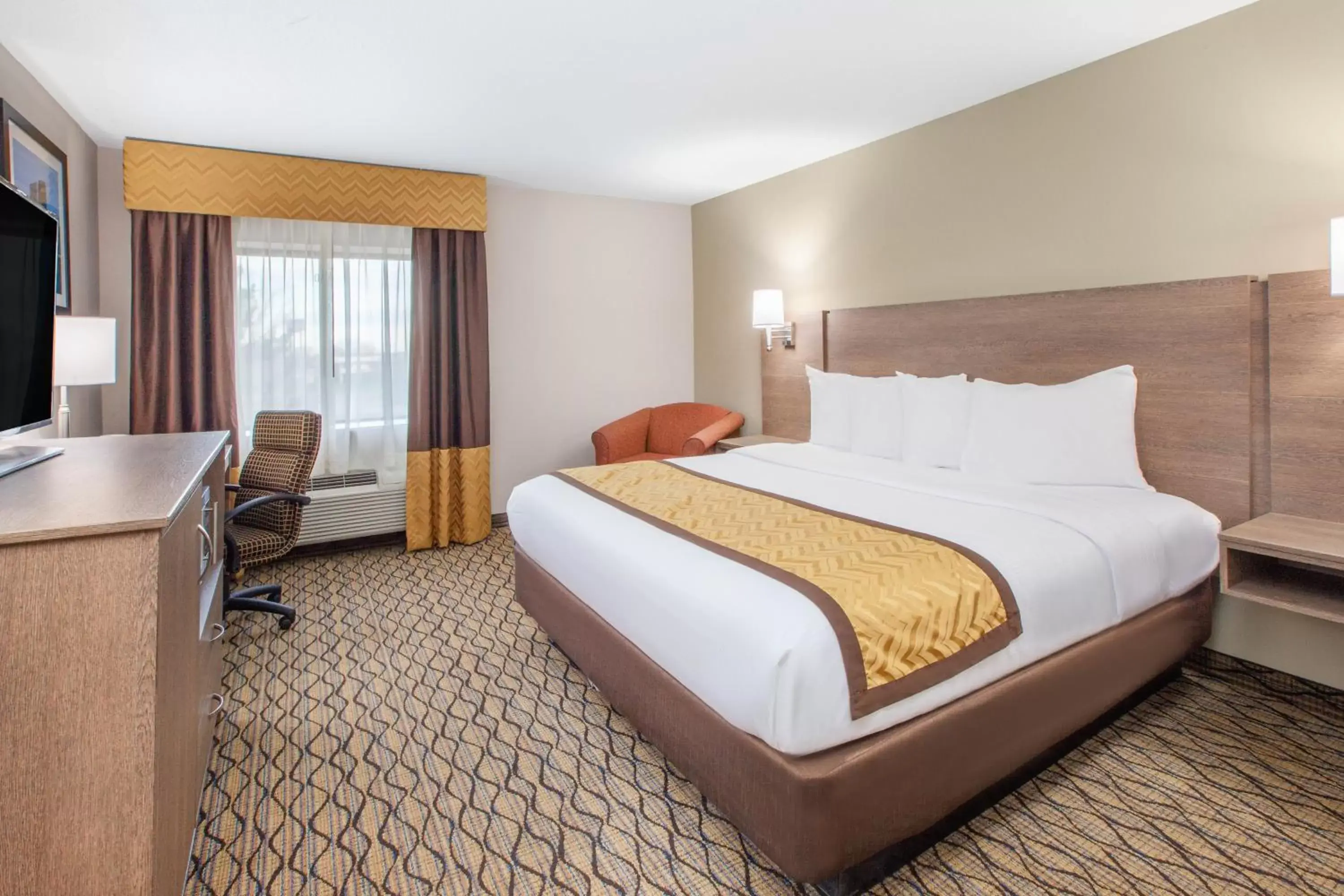 Bed in Baymont by Wyndham Grand Rapids Airport