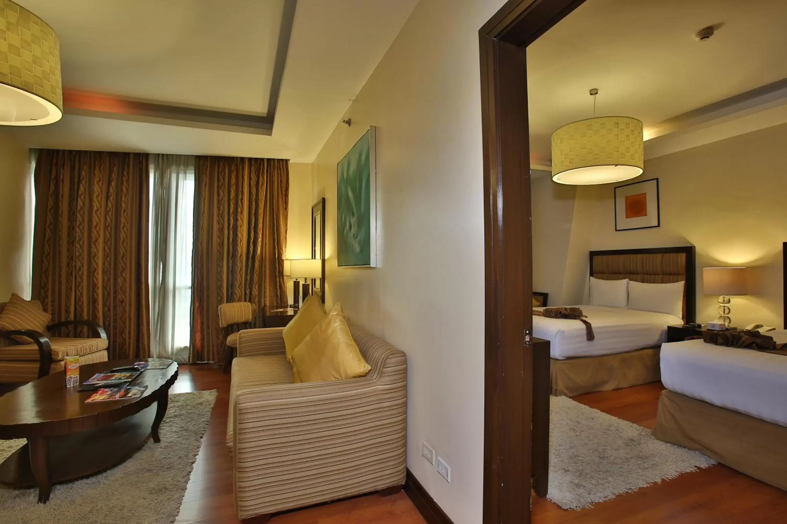 Living room, Bed in Crown Regency Hotel & Towers