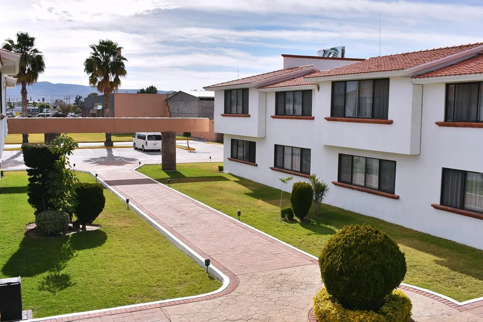 Garden, Property Building in La Posada Hotel y Suites