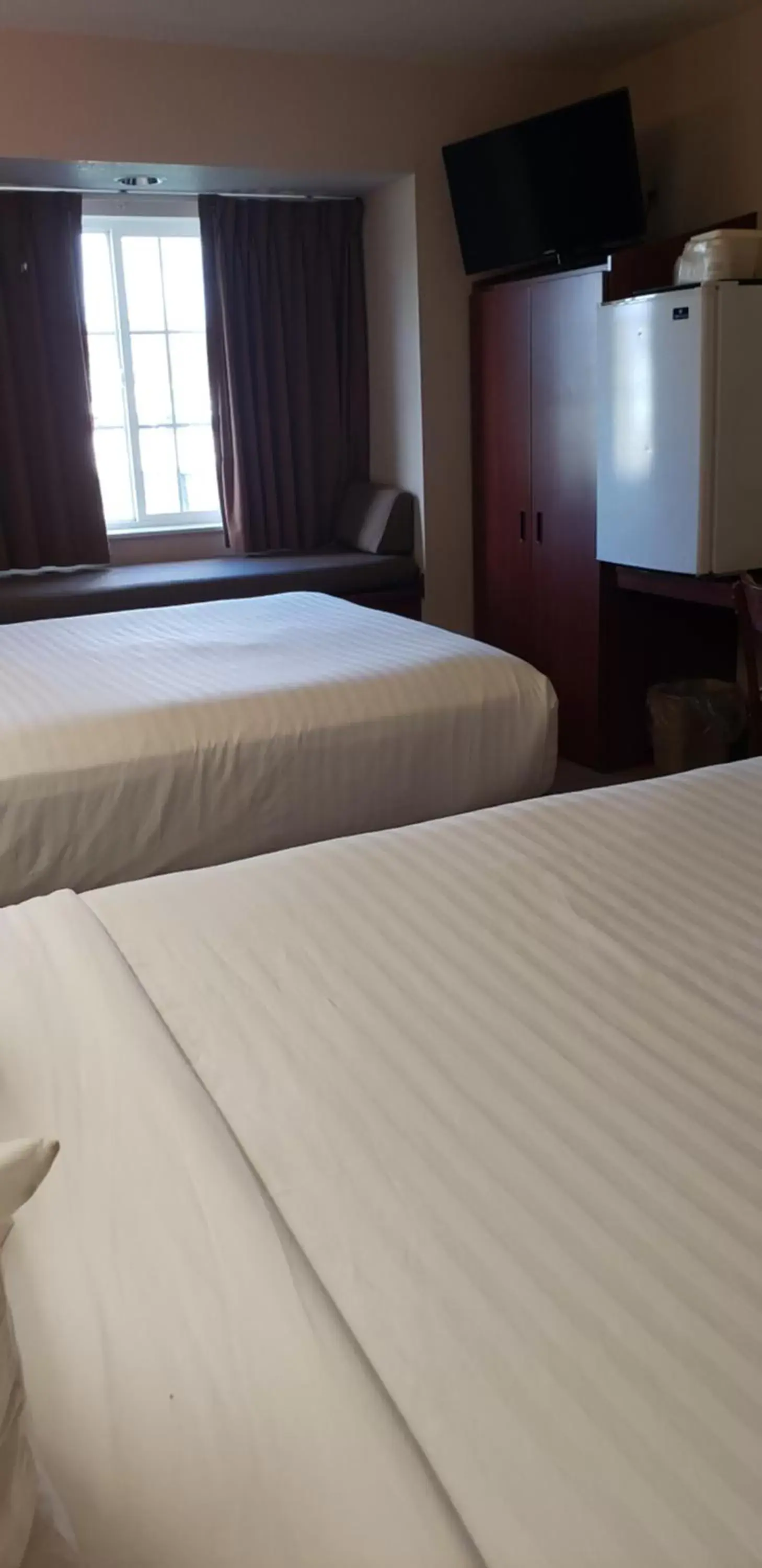 Bed in Microtel Inn & Suites by Wyndham Wellsville