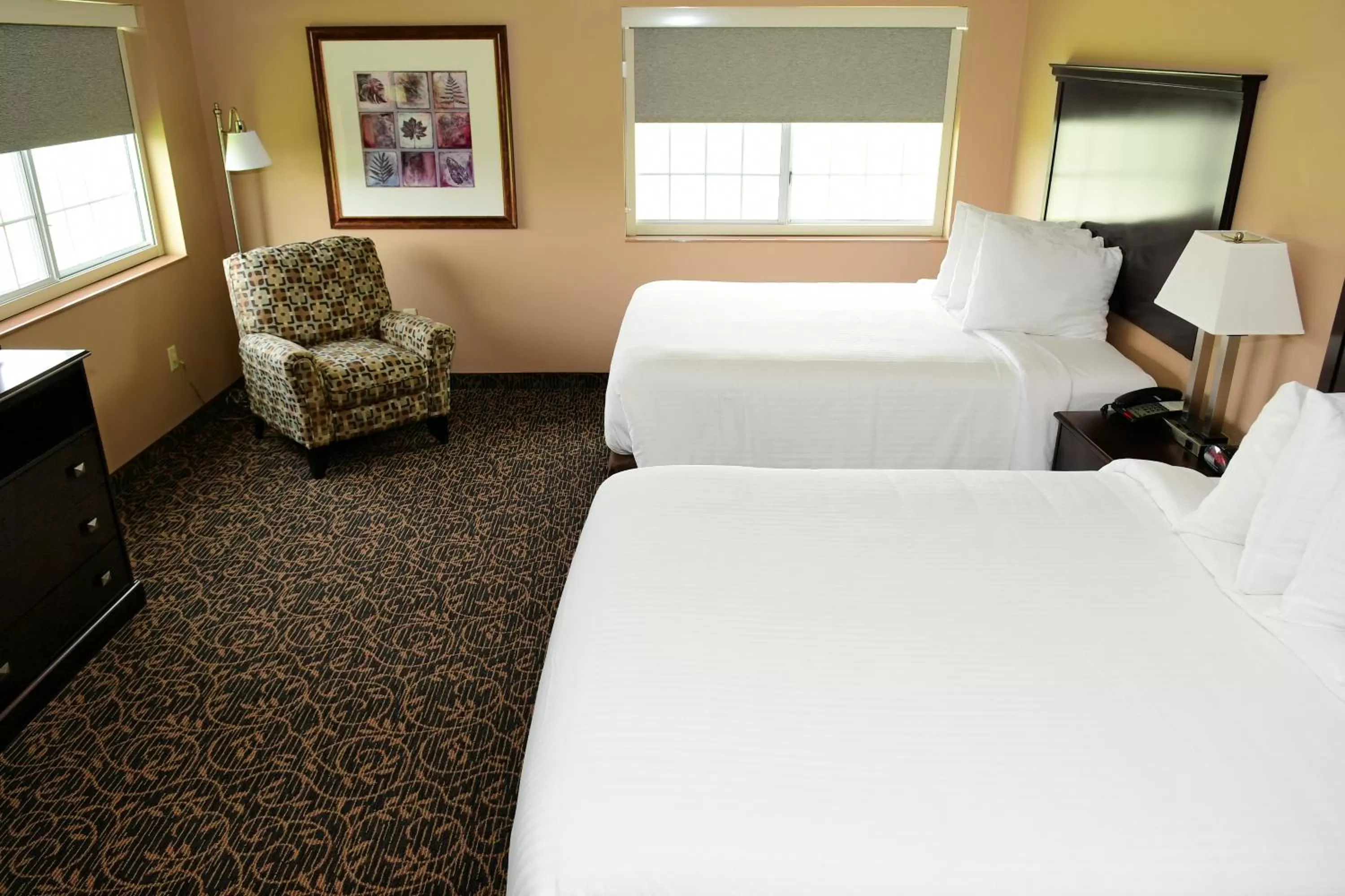 Bed in Cobblestone Inn & Suites - Denison | Majestic Hills