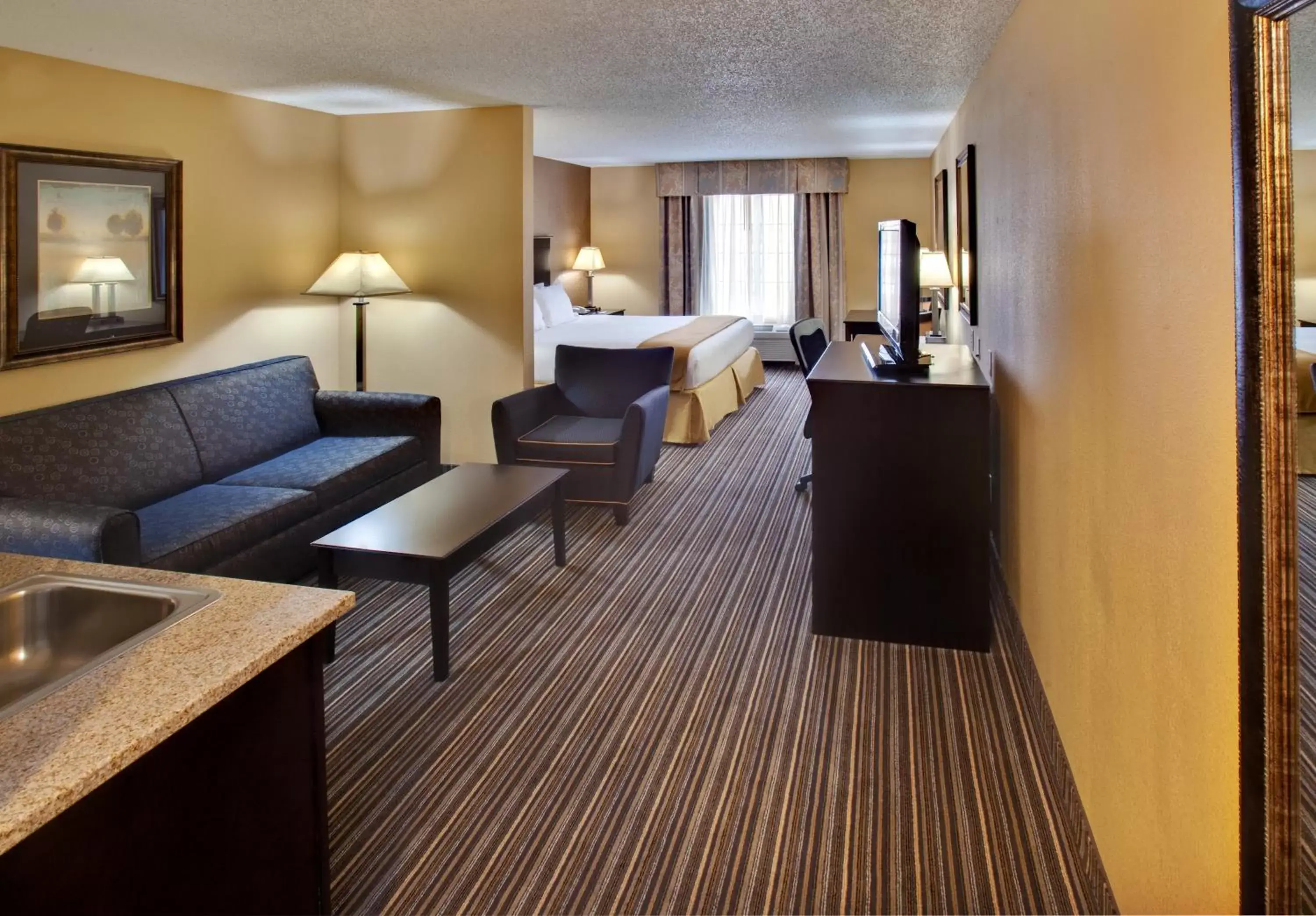 Bedroom, Seating Area in Holiday Inn Express Hotel & Suites Council Bluffs - Convention Center Area, an IHG Hotel