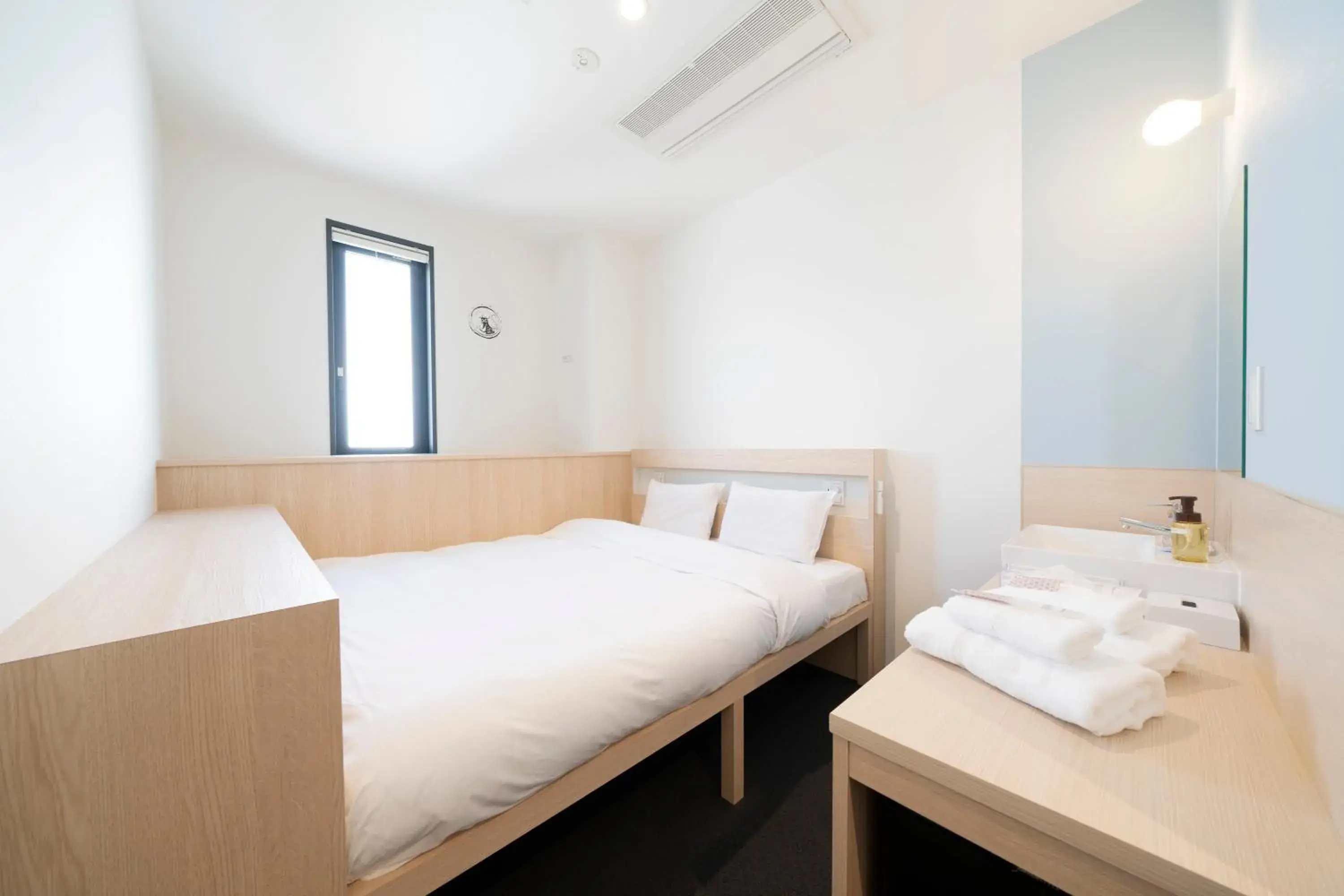 Photo of the whole room, Bed in WeBase Hiroshima