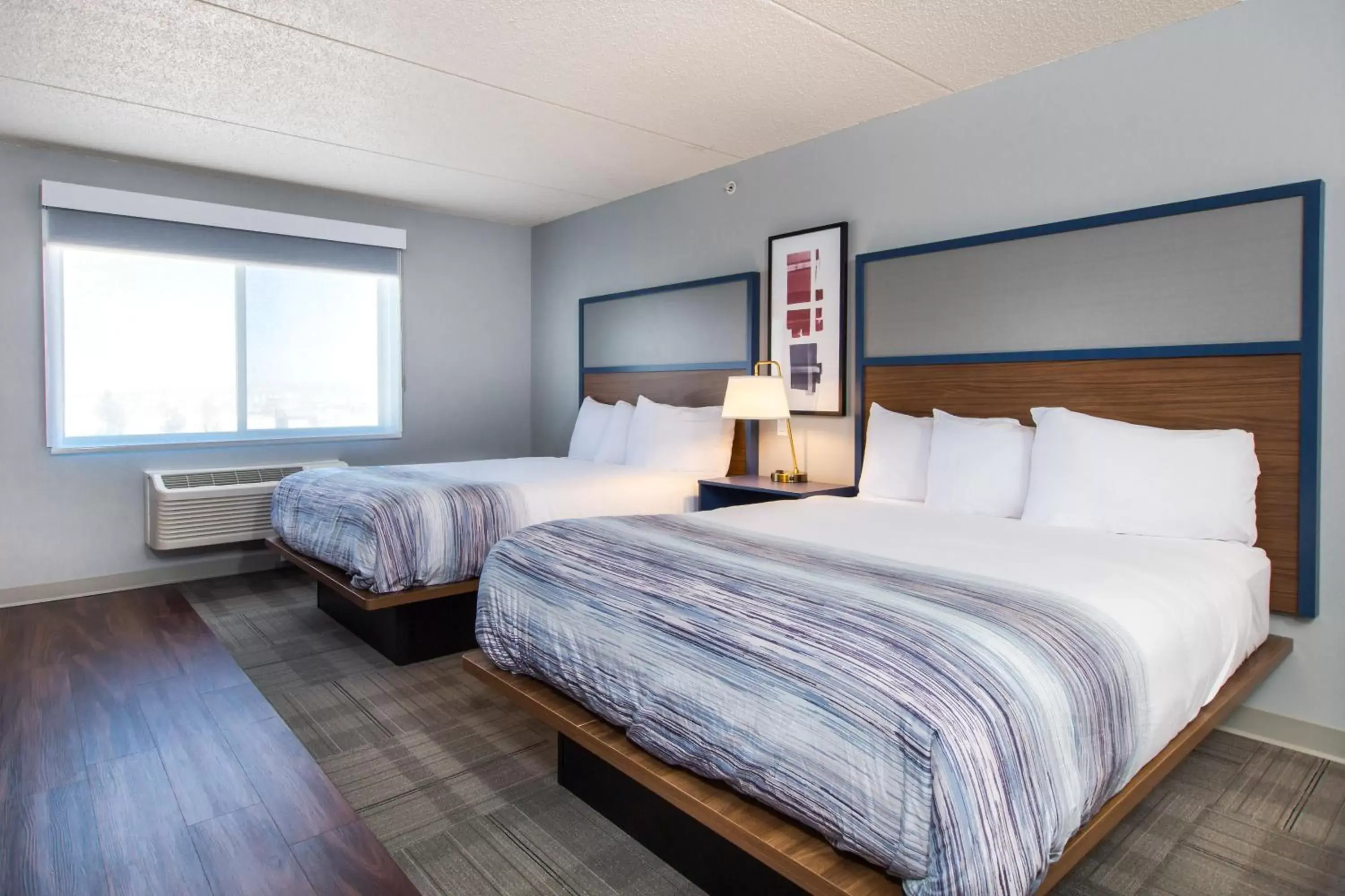 Bed in AmericInn by Wyndham Rapid City