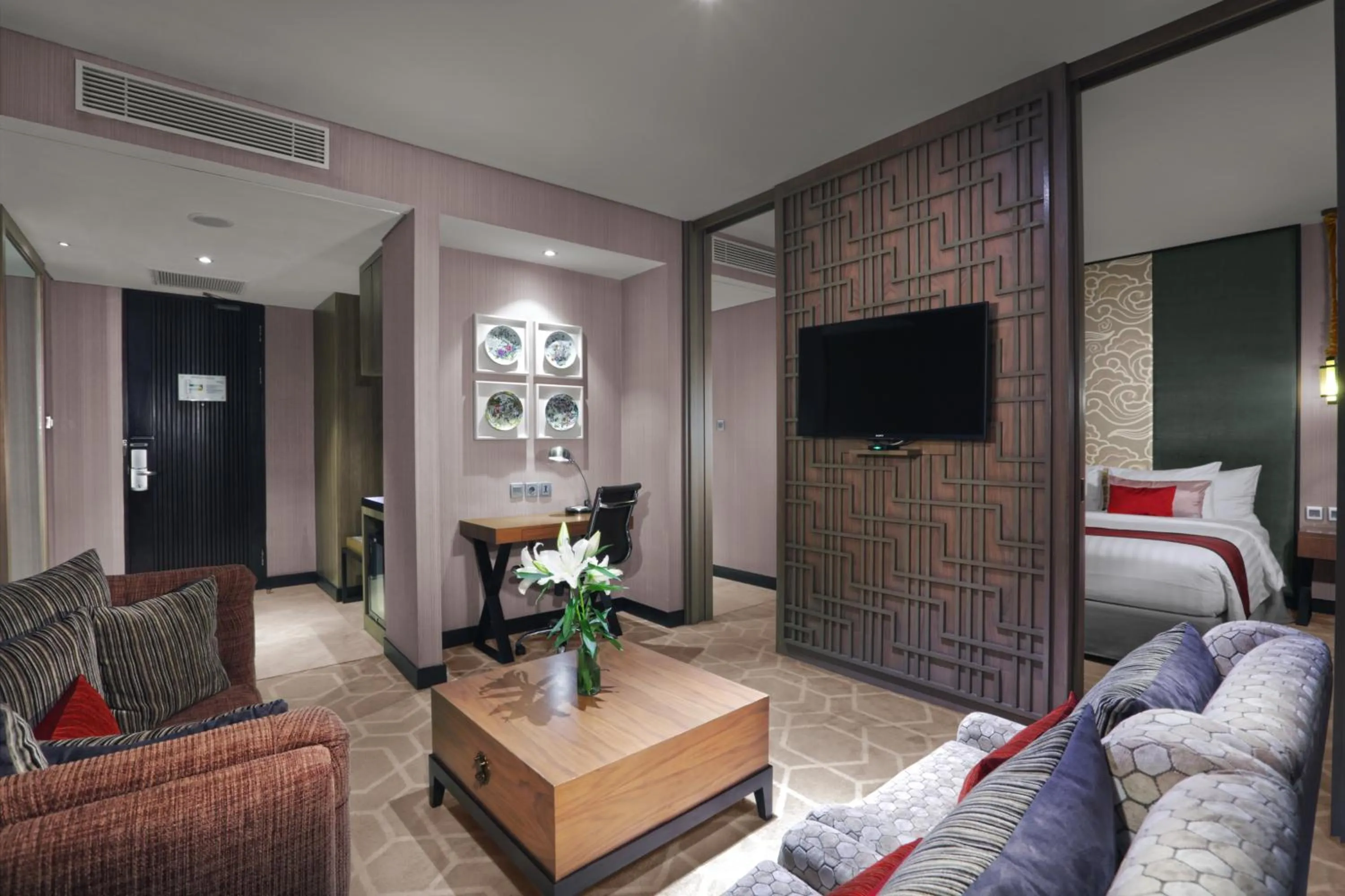 Communal lounge/ TV room, Bed in Aston Priority Simatupang Hotel and Conference Center
