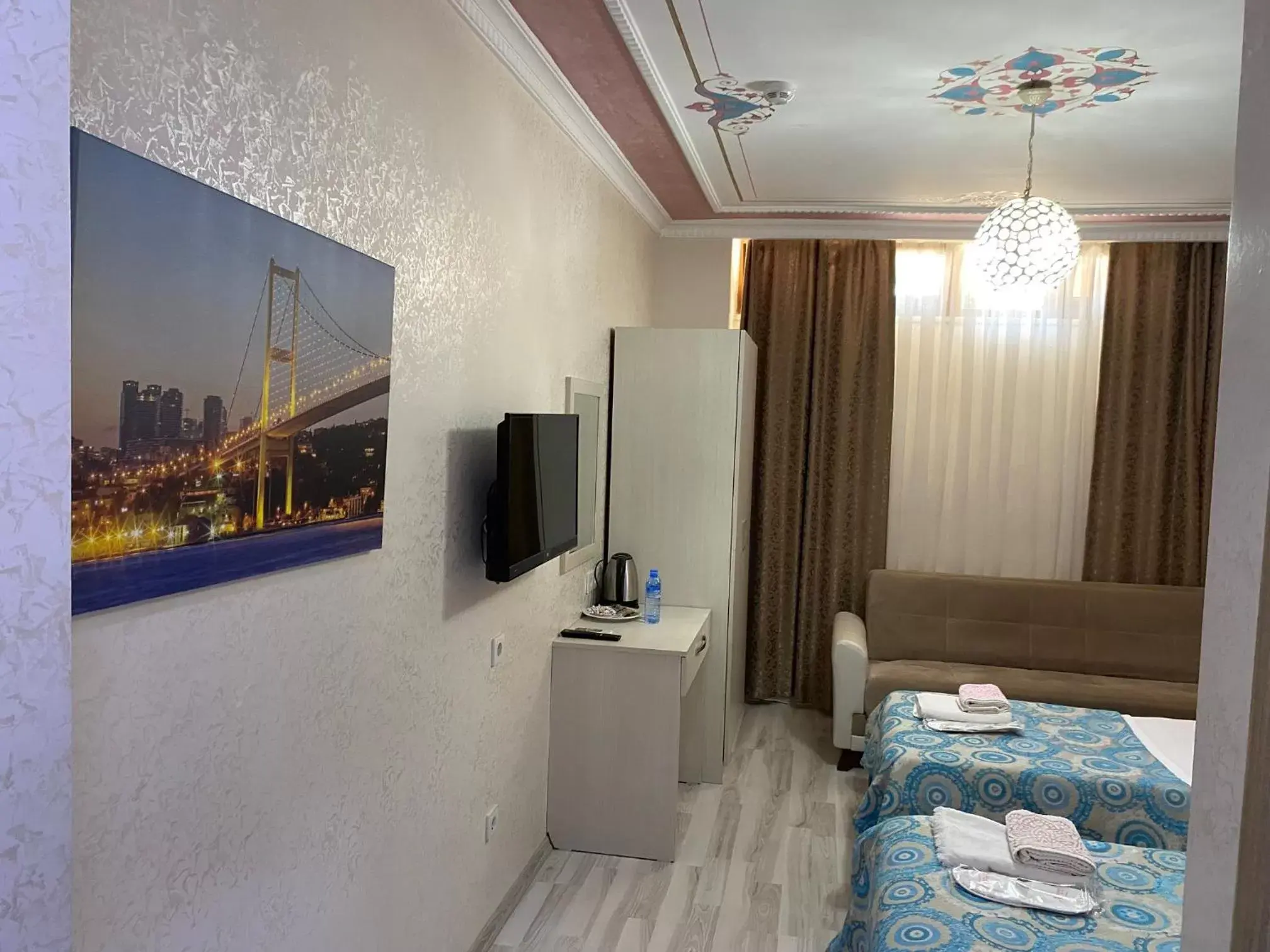Bed, TV/Entertainment Center in Atam Suites