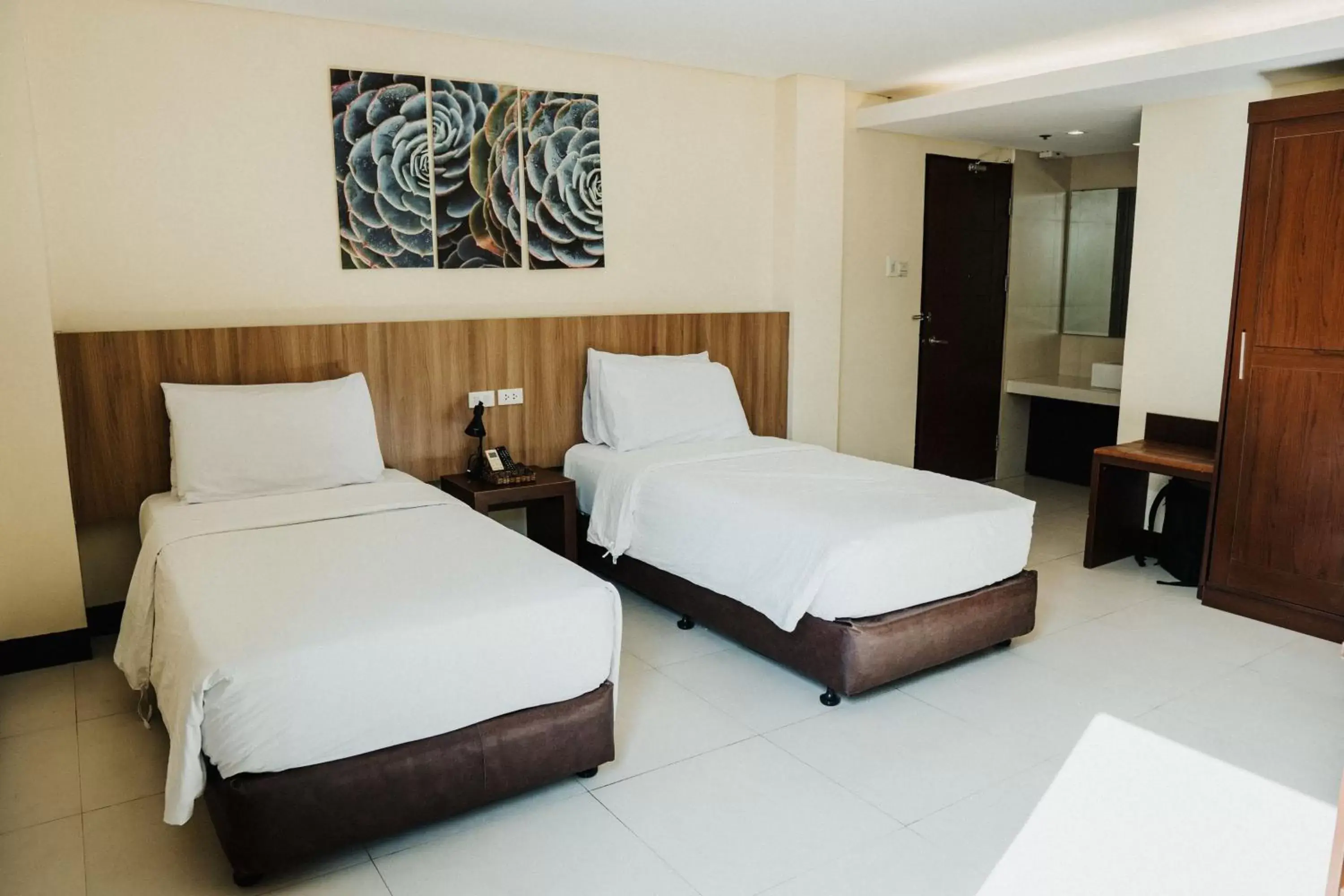 Bed in Ocean Suites Bohol Boutique Hotel