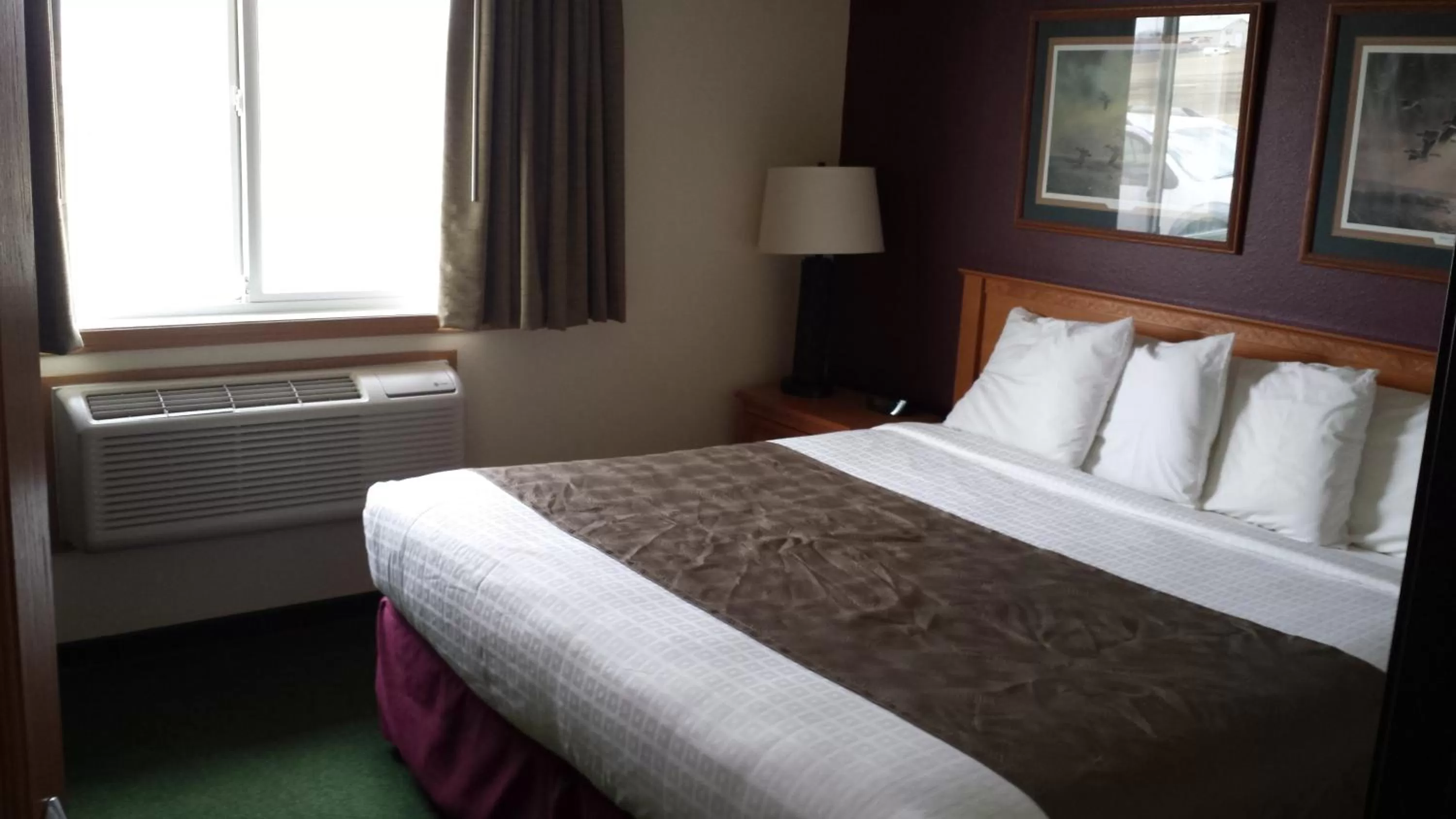 Bed in AmericInn by Wyndham Madison SD