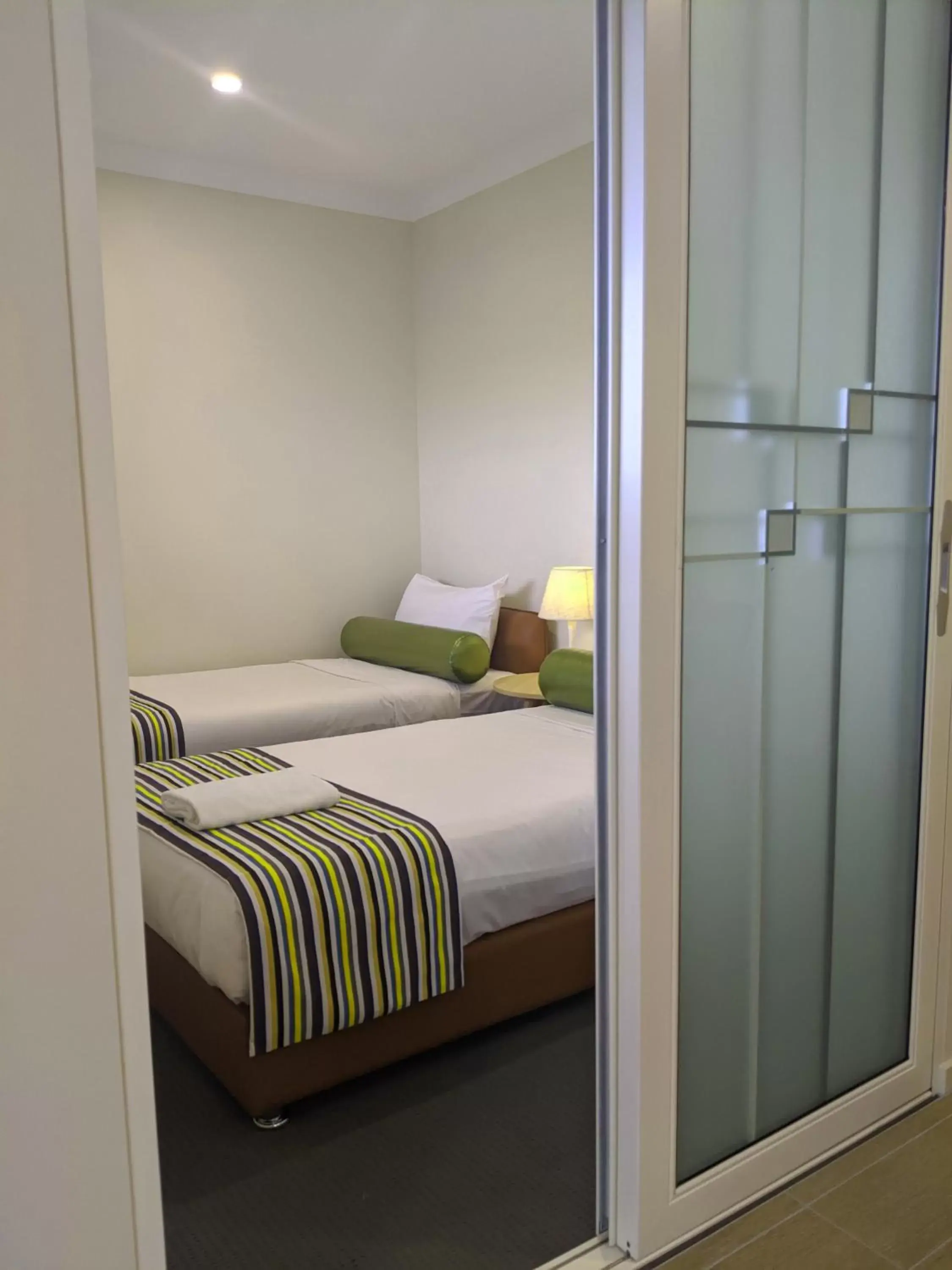 Bed in The Windsor Apartments and Hotel Rooms, Brisbane