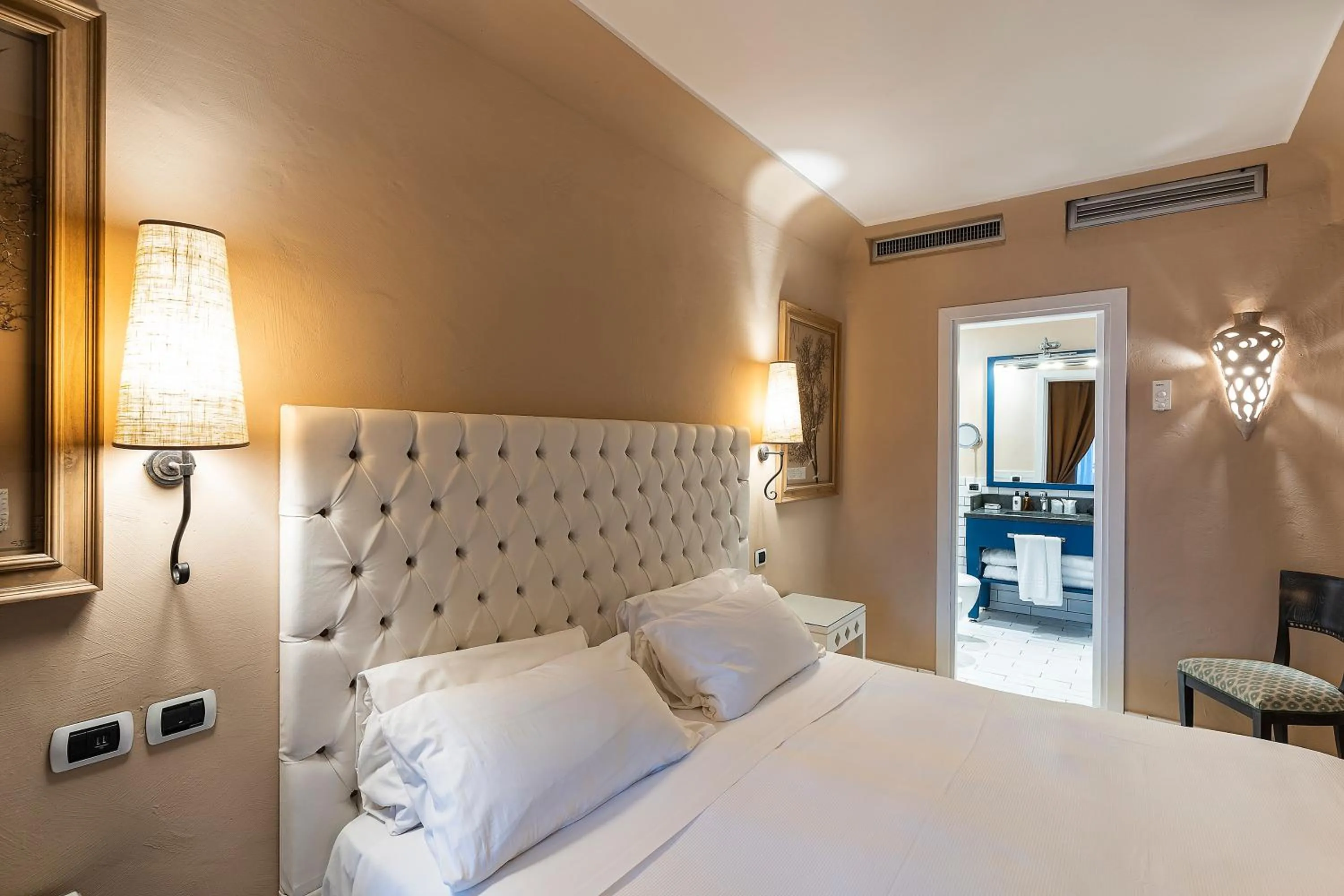 Bed in Therasia Resort Sea and SPA - The Leading Hotels of the World