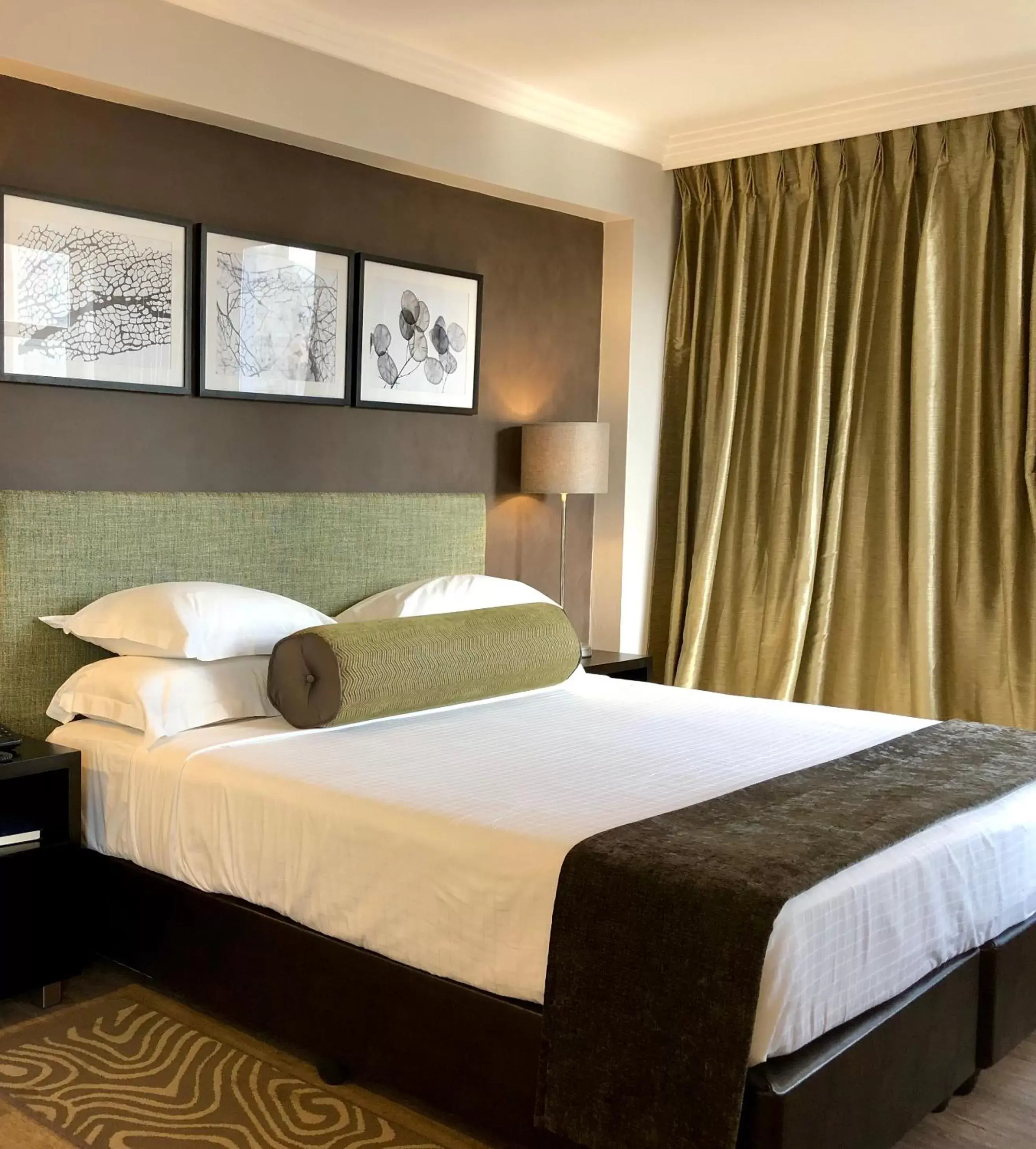 Bed in Belaire Suites Hotel