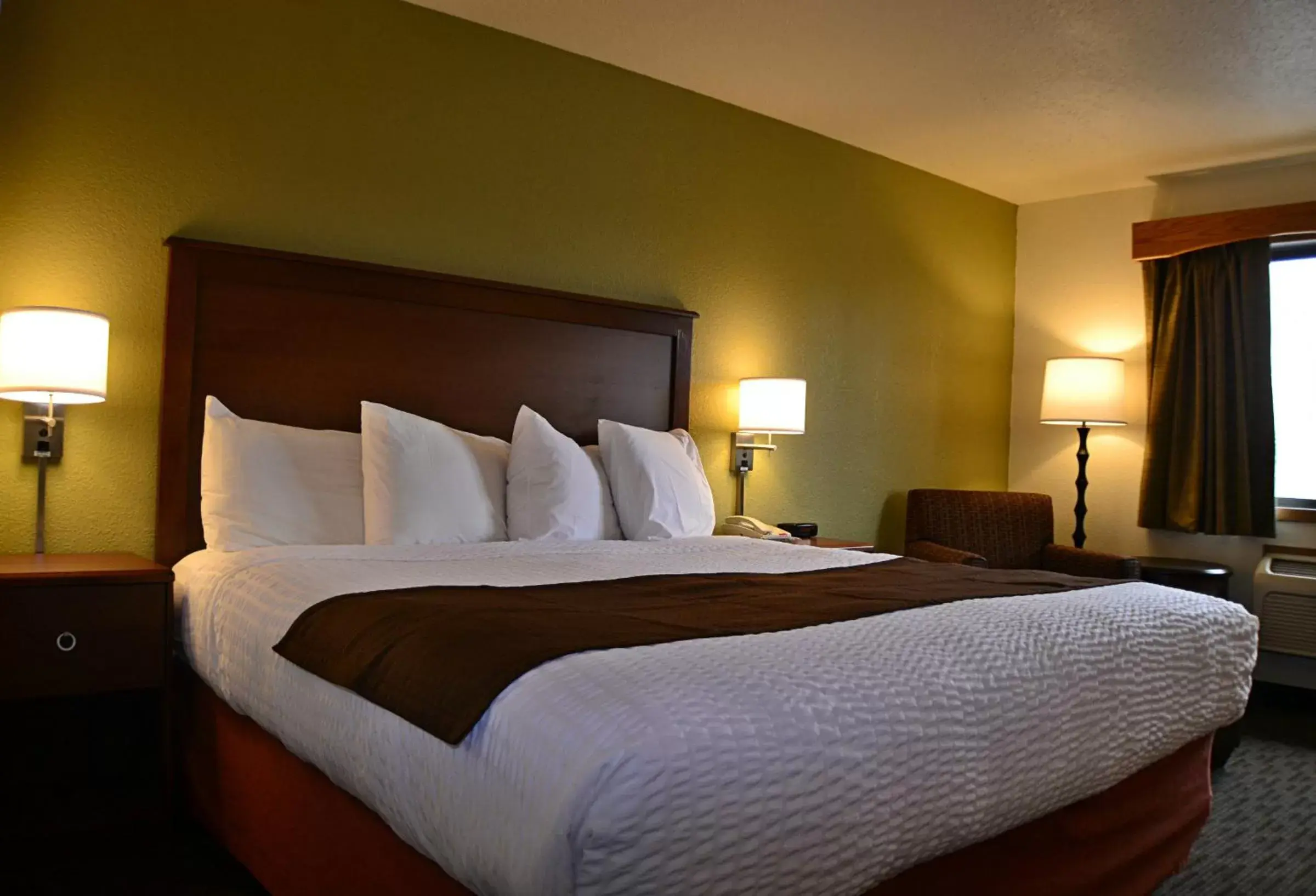 Bed in AmericInn by Wyndham Calumet