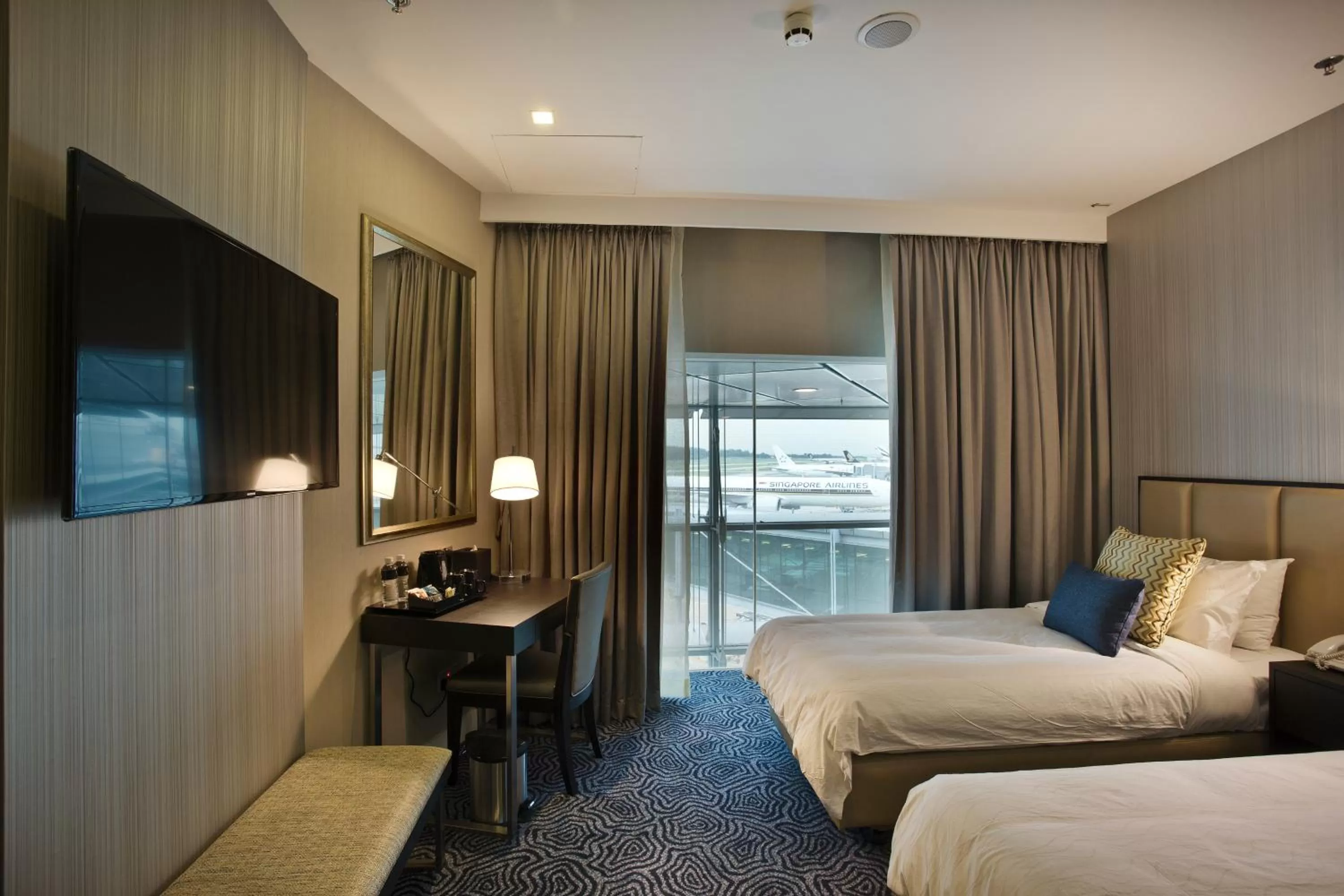 Photo of the whole room, TV/Entertainment Center in Ambassador Transit Hotel - Terminal 3