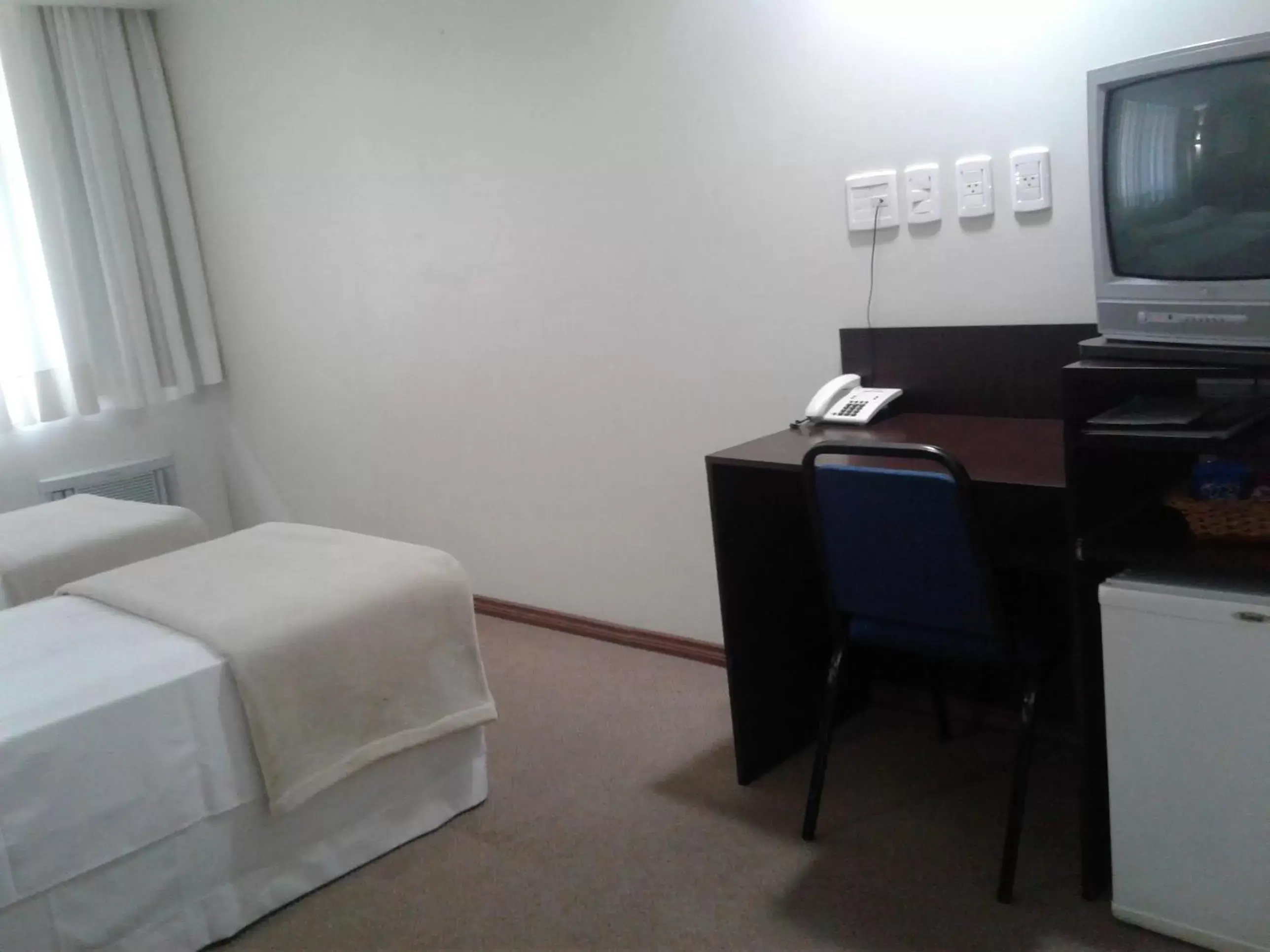 Photo of the whole room, TV/Entertainment Center in Coral Hotel - Próximo Av Carlos Gomes, PUCRS