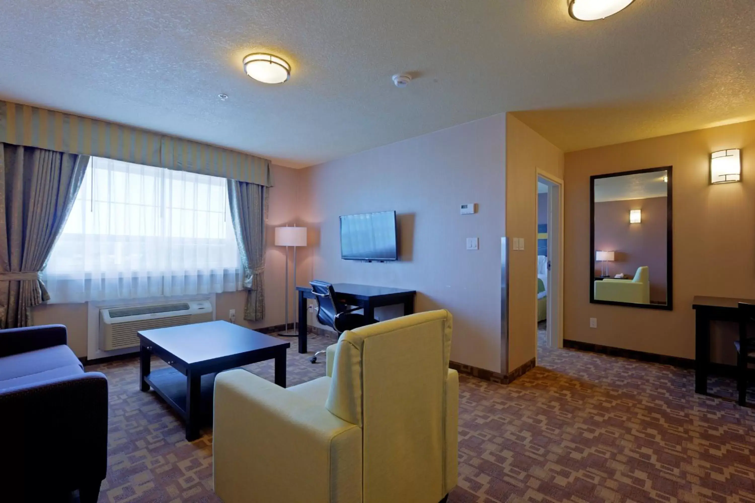 Bedroom, Seating Area in Holiday Inn Express and Suites Dawson Creek, an IHG Hotel
