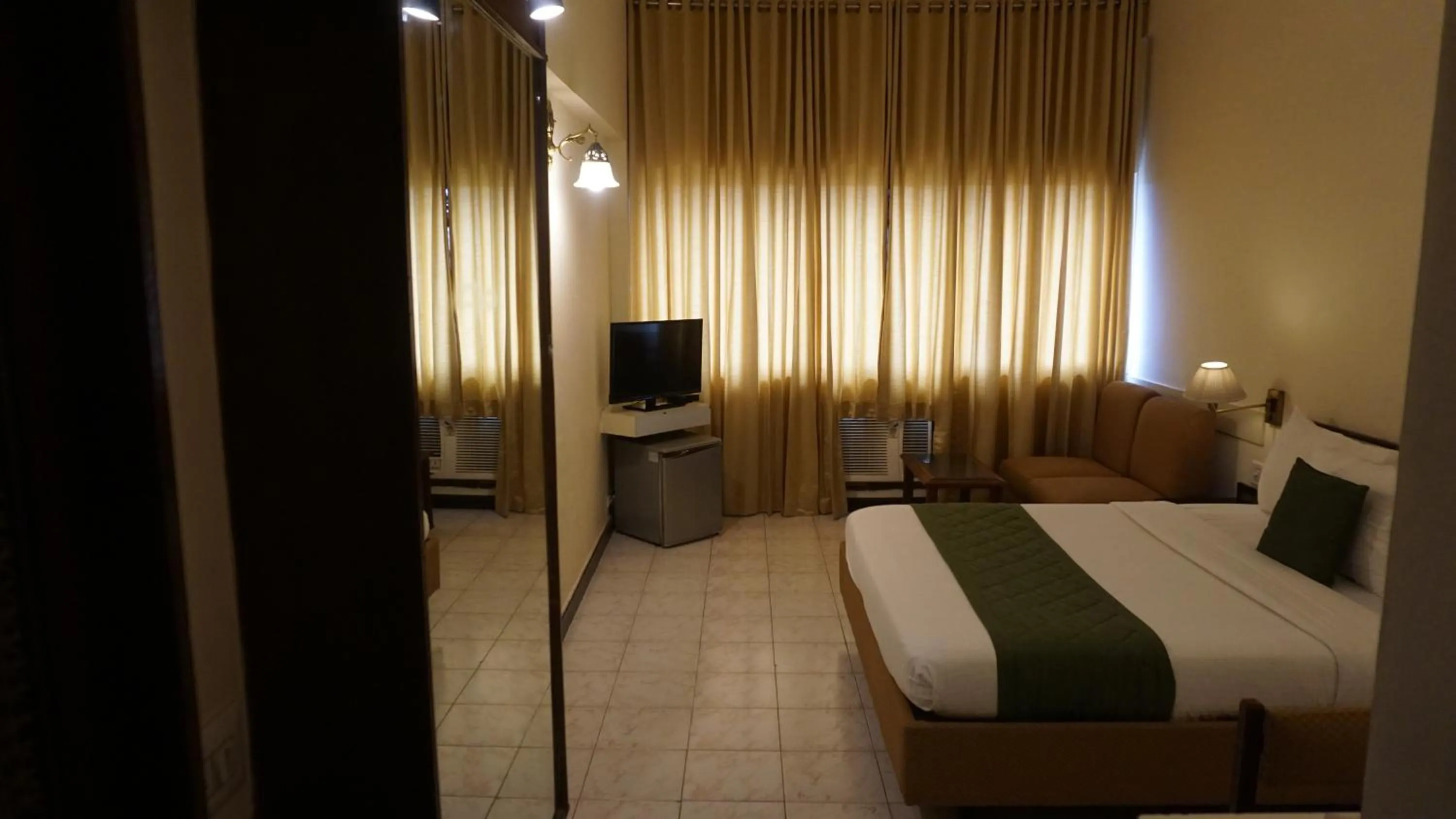 Bed in Hotel Poonja International