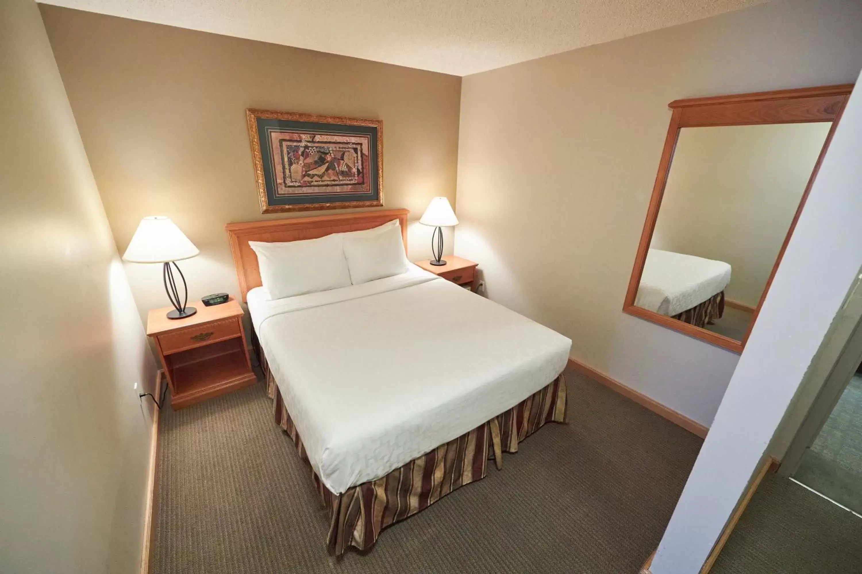 Bed in Jasper Inn & Suites by INNhotels