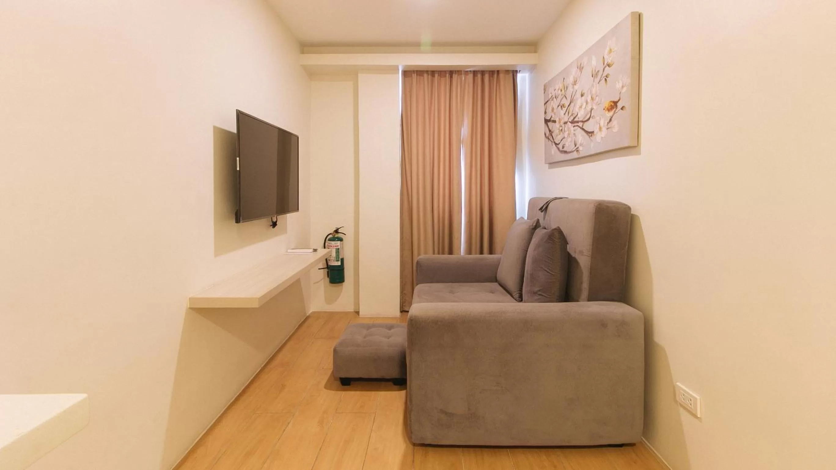 Seating area in RedDoorz Plus at La Belle Residences Makati City