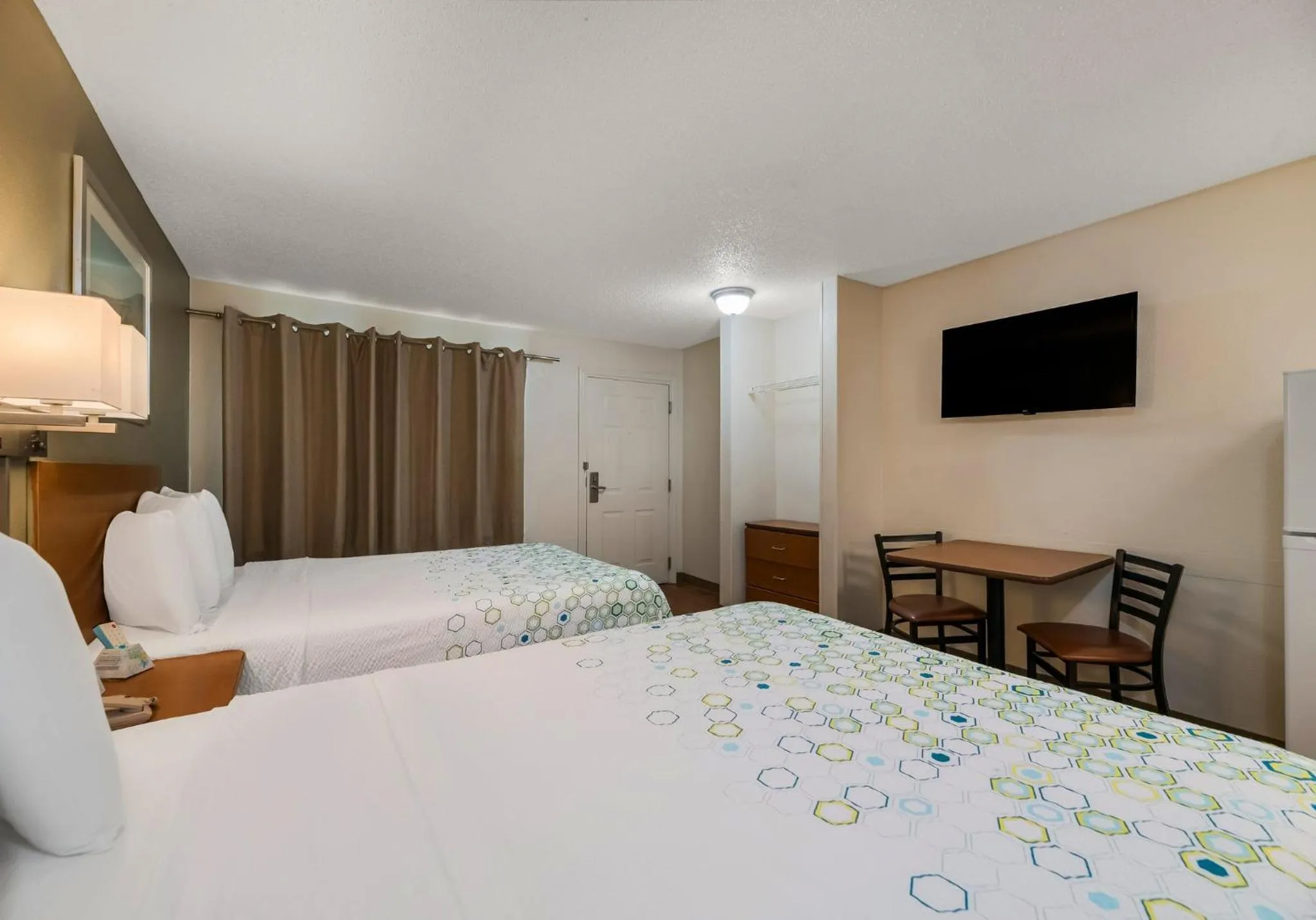 Bedroom, Bed in HomeTowne Studios by Red Roof Orlando - UCF Area