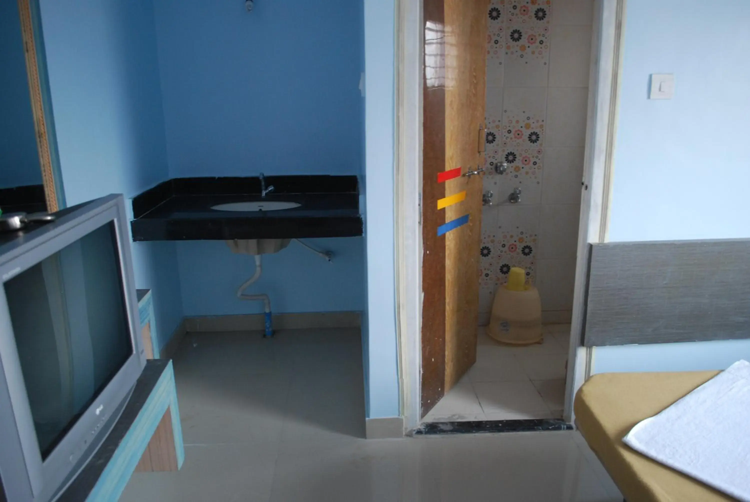 Toilet, TV/Entertainment Center in Hotel Utsav