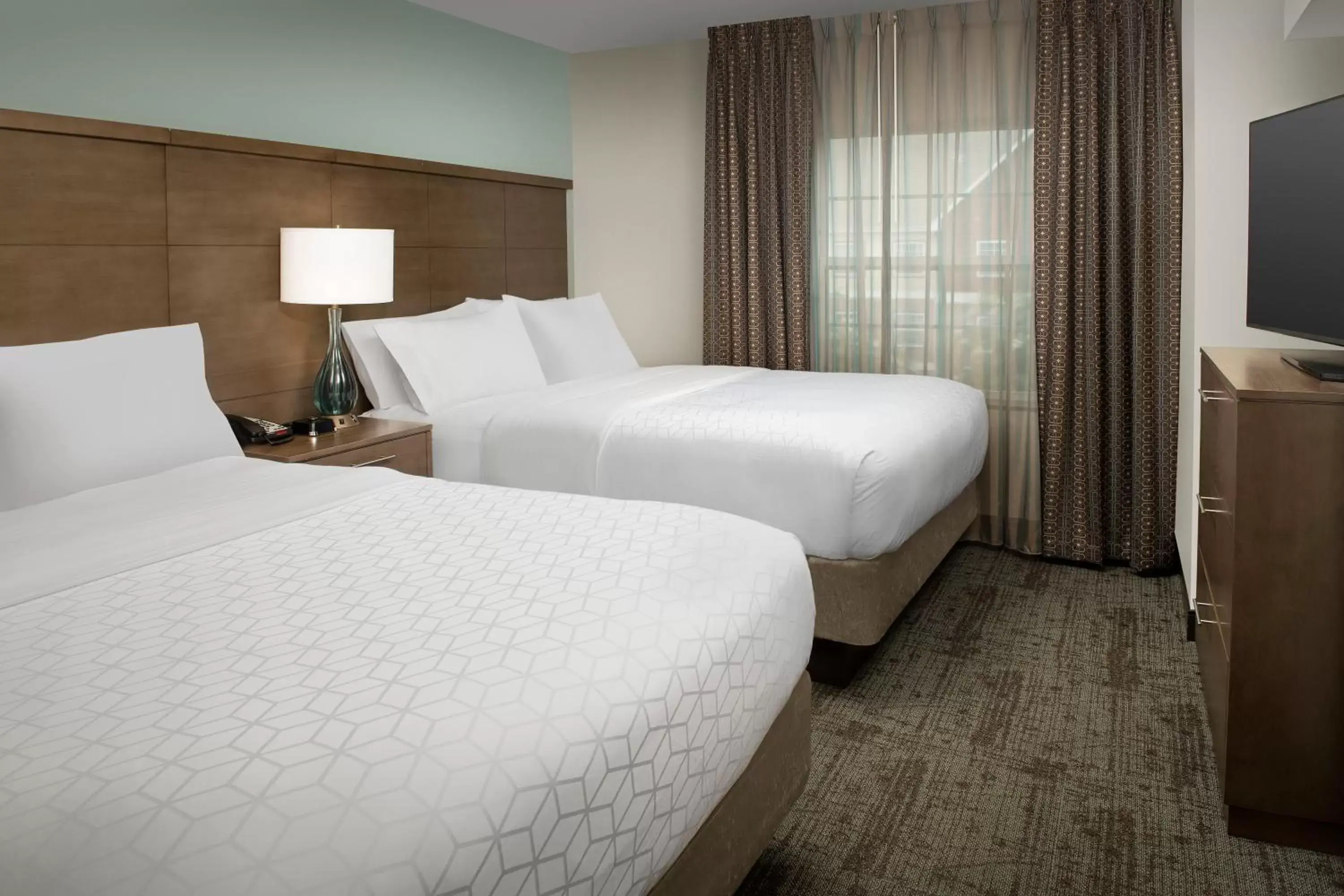 Bed in Staybridge Suites Greenville I-85 Woodruff Road, an IHG Hotel