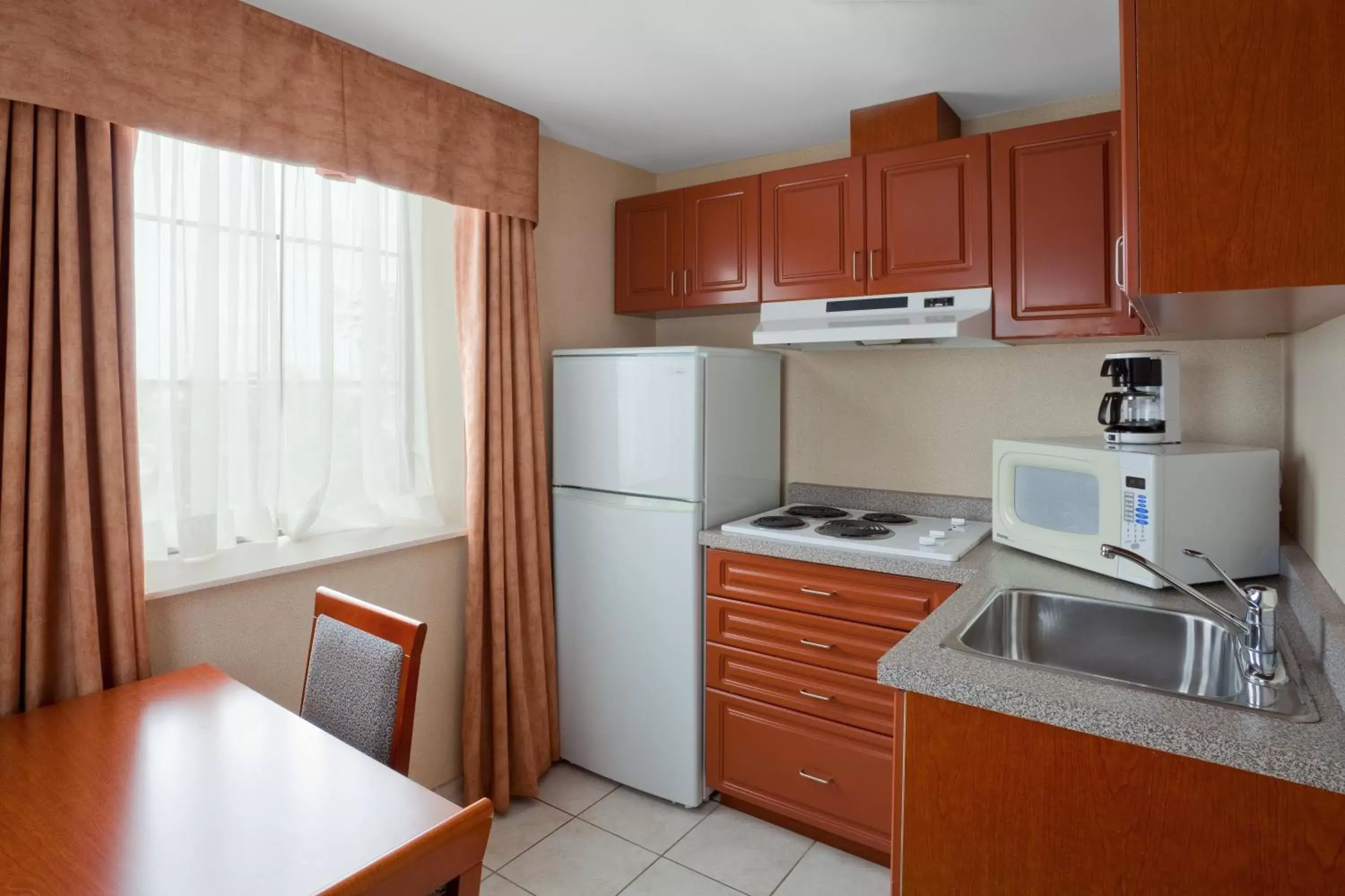 Bedroom, Kitchen/Kitchenette in Holiday Inn Express Hotel & Suites Barrie, an IHG Hotel