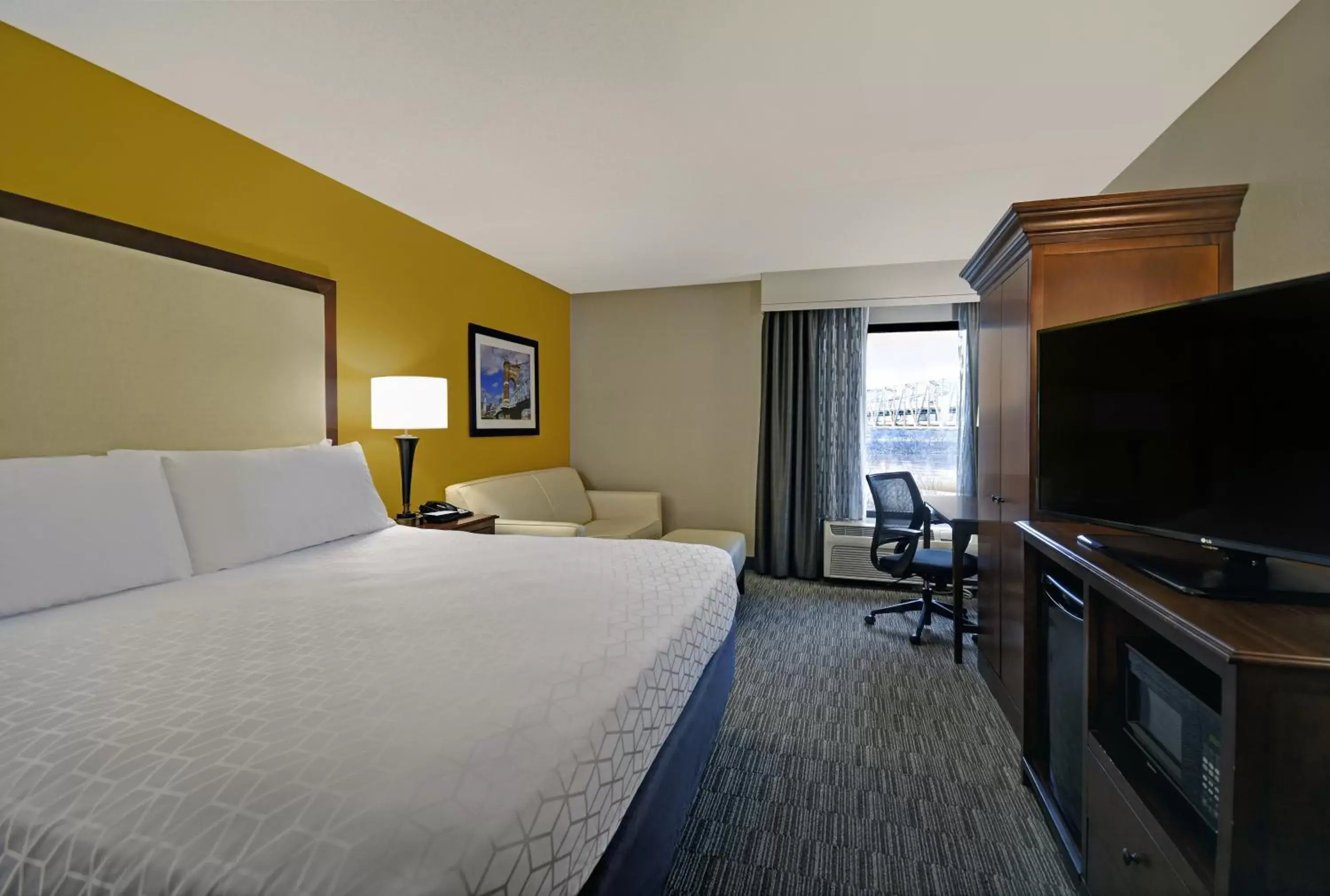 Photo of the whole room, TV/Entertainment Center in Holiday Inn Express & Suites Cincinnati Riverfront, an IHG Hotel