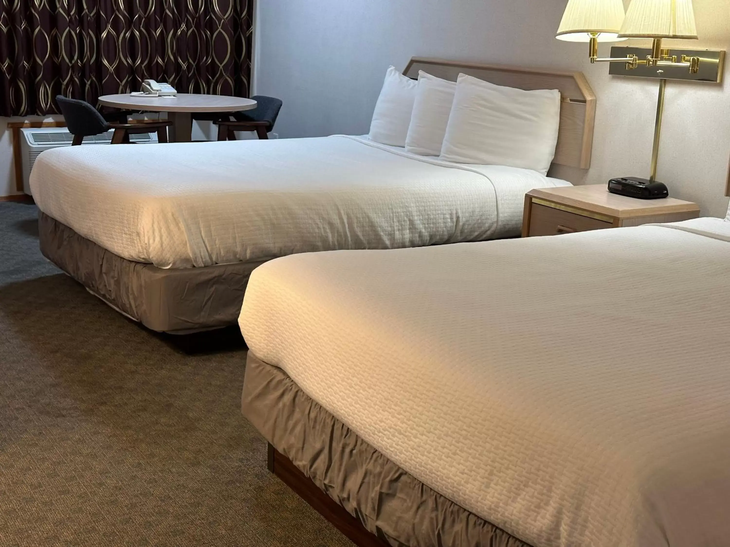Bed in Timberland Inn & Suites