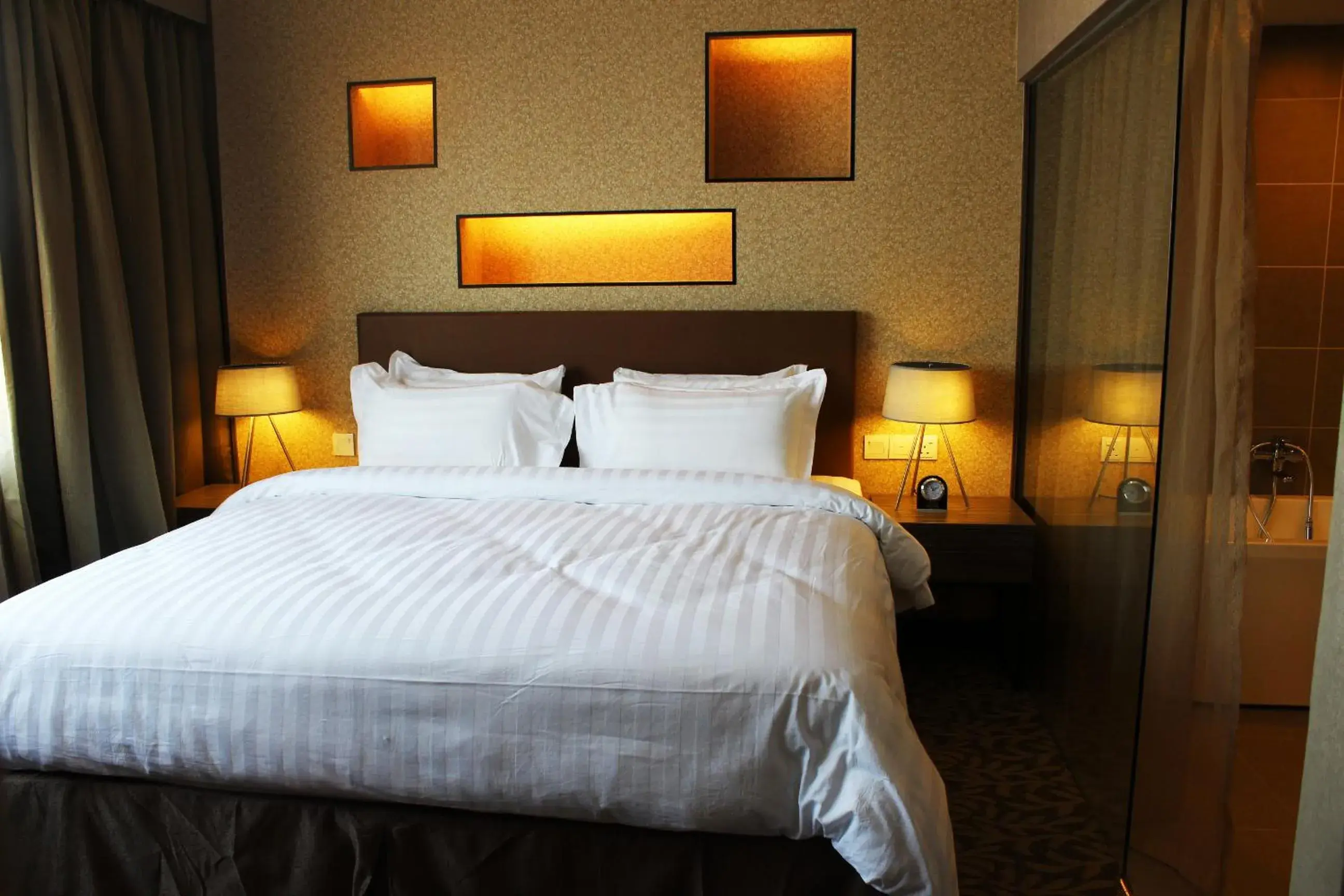 Bed in Grand Alora Hotel