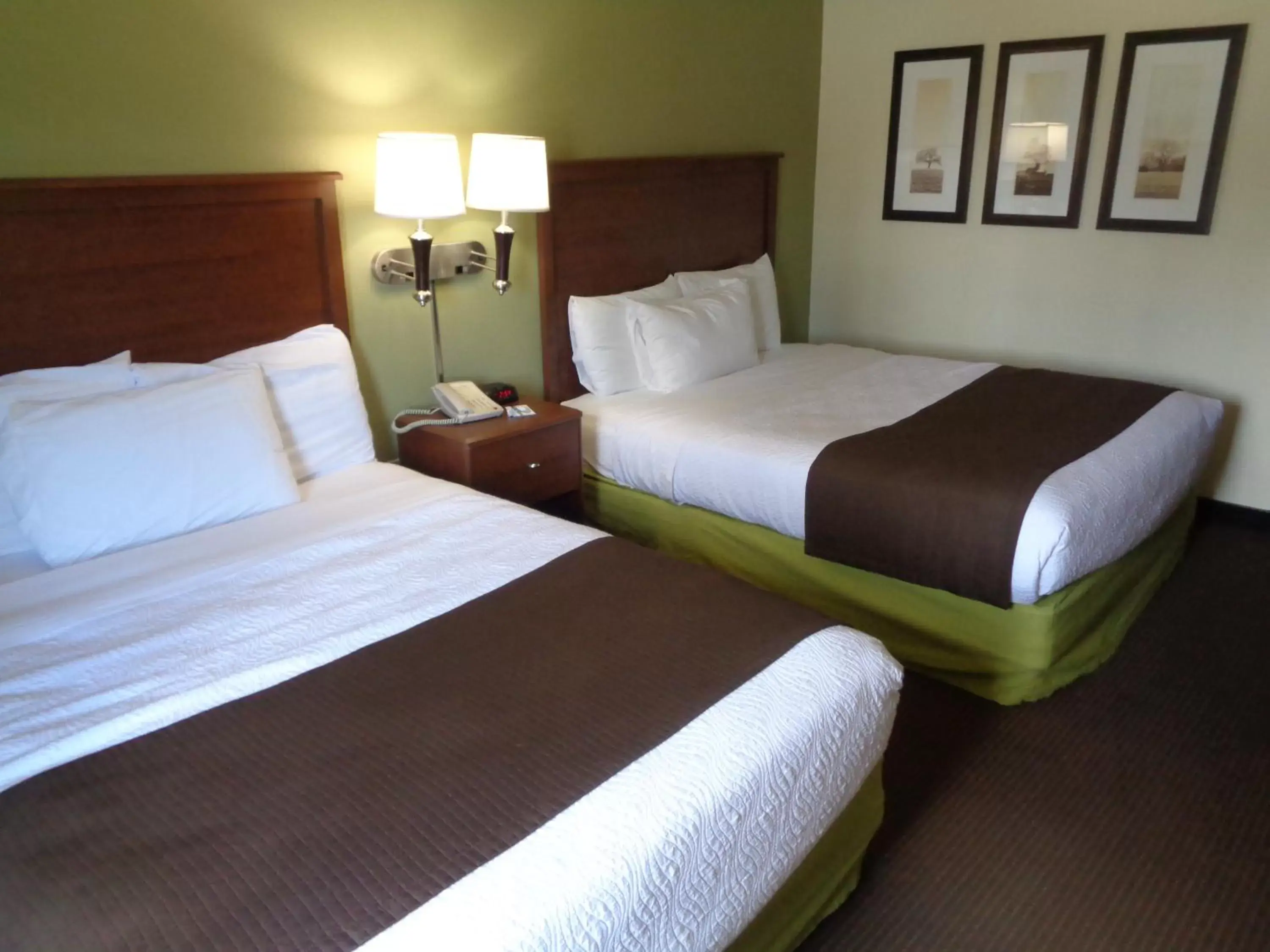 Bed in AmericInn by Wyndham Grand Rapids