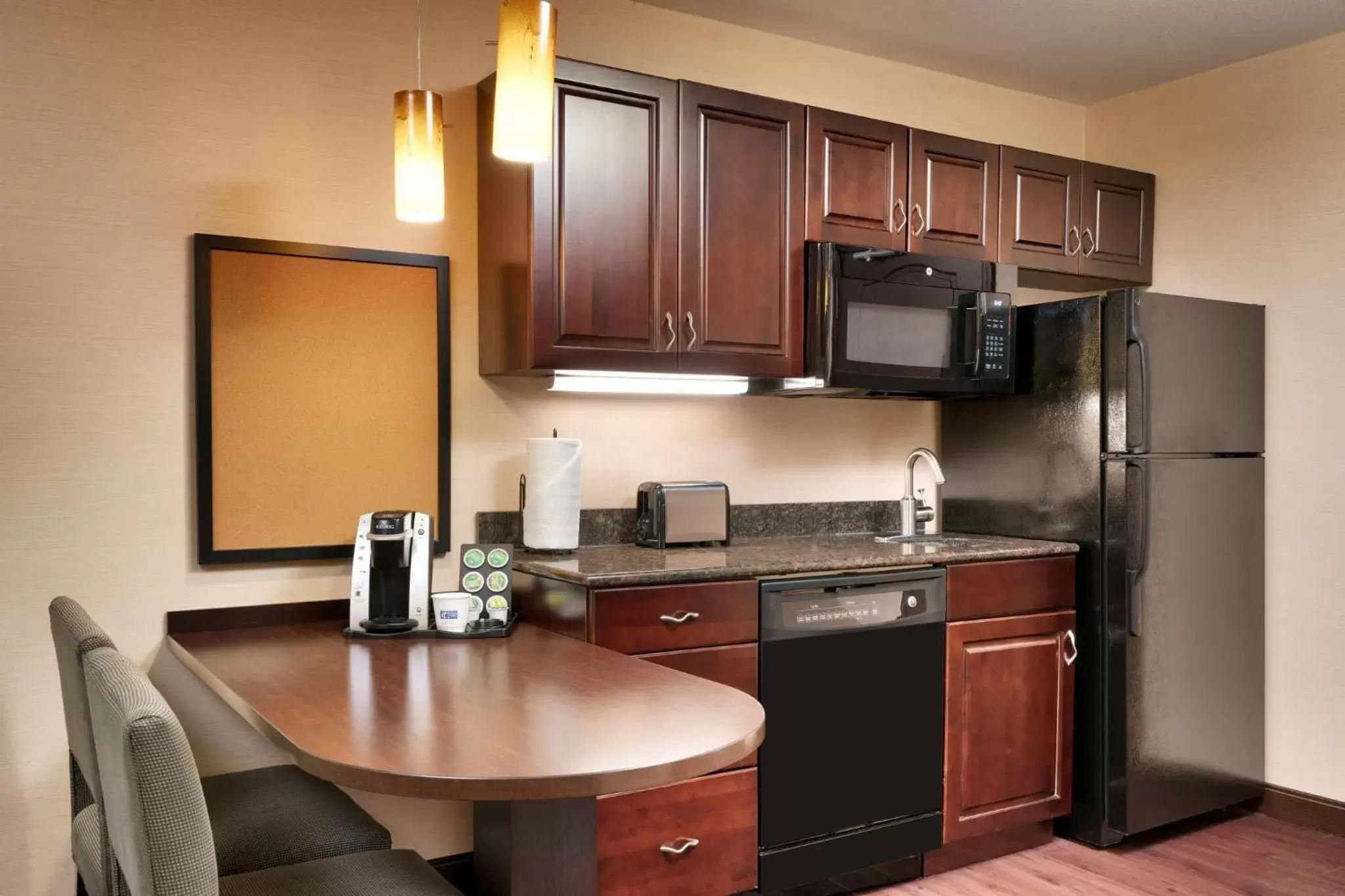 Bedroom, Kitchen/Kitchenette in Holiday Inn Express Hotel & Suites Butte, an IHG Hotel