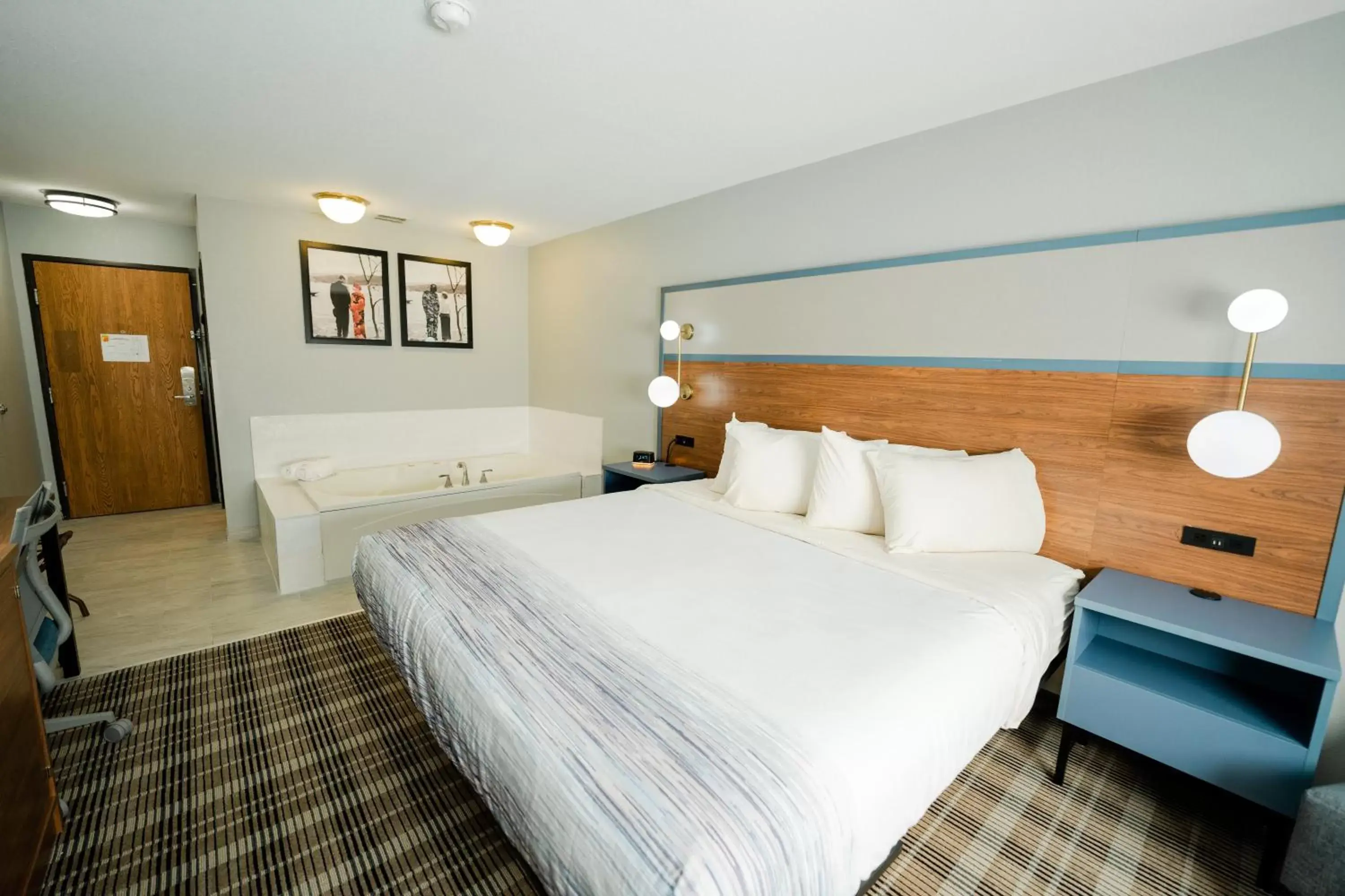 Bed in AmericInn by Wyndham Tomahawk