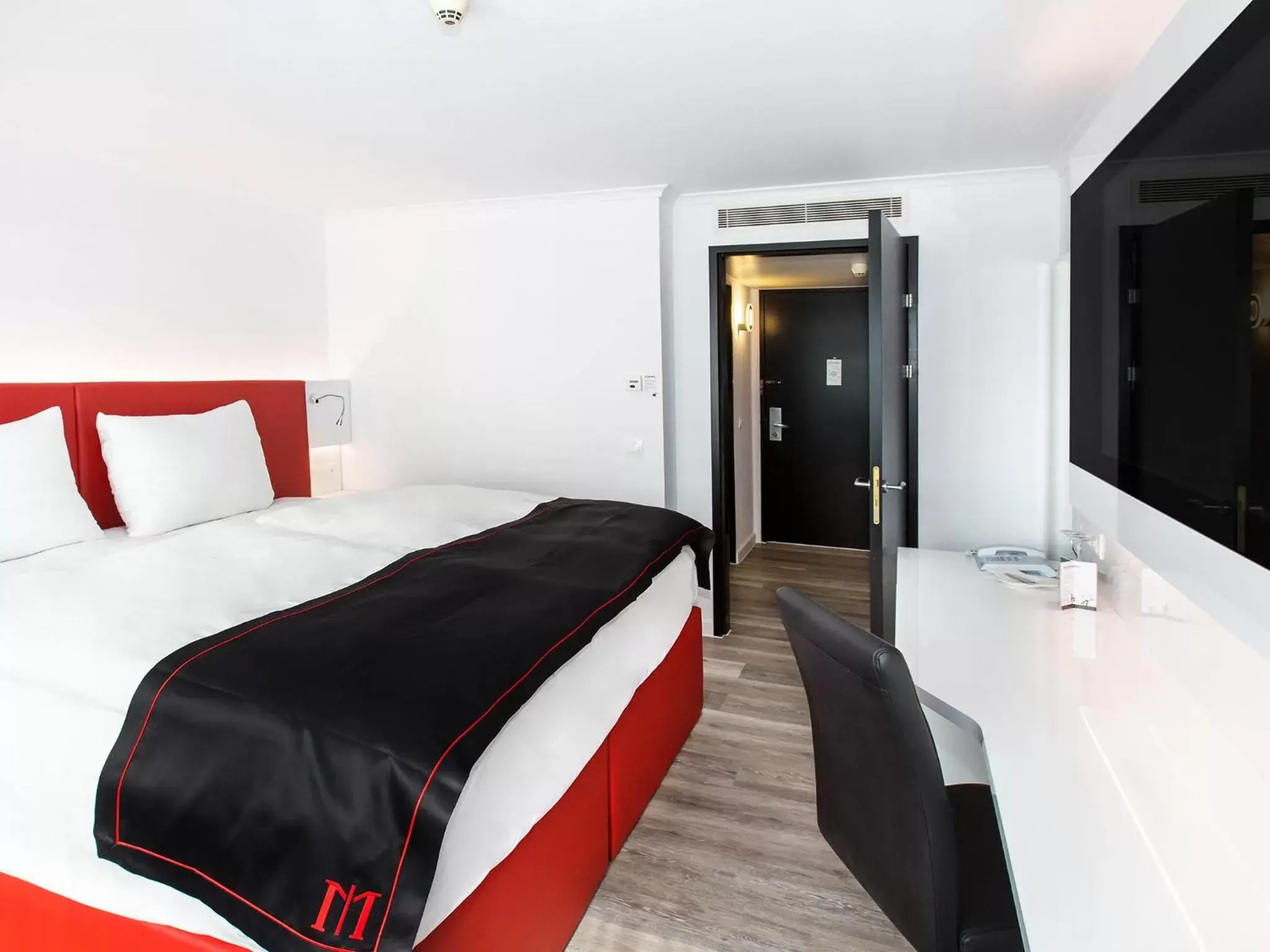 Photo of the whole room, Bed in DORMERO Hotel Zürich Airport