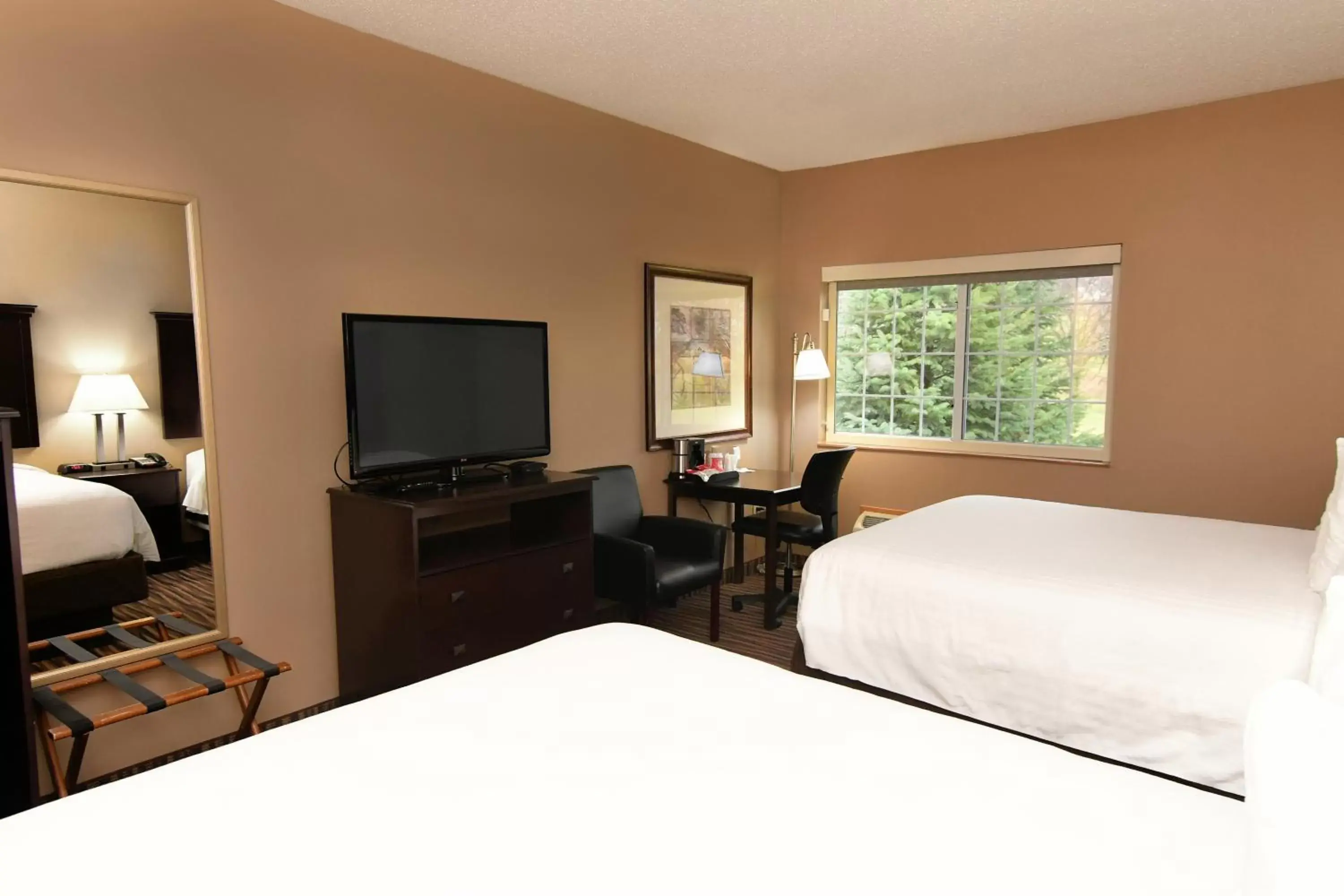 Bed in Cobblestone Inn & Suites - Denison | Majestic Hills