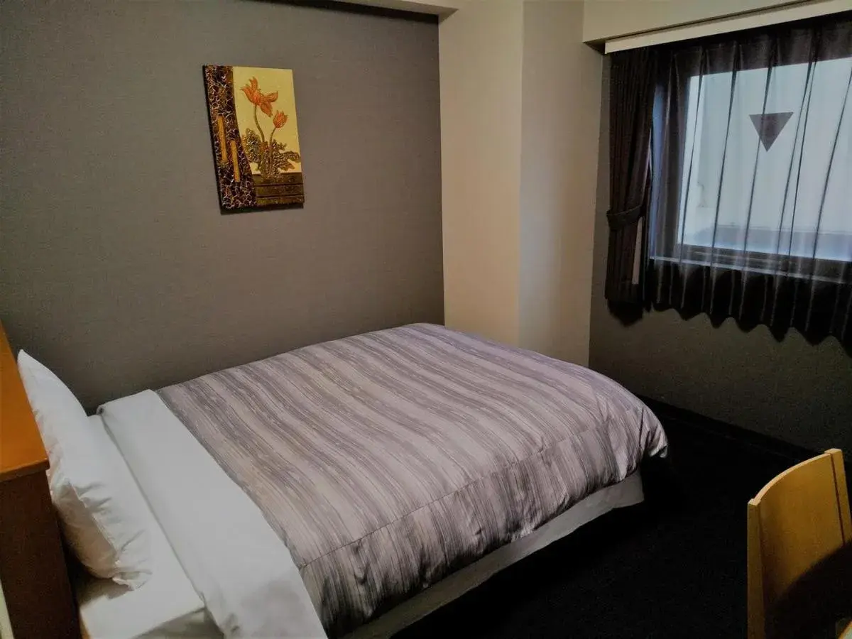 Bed in Route Inn Grantia Akita Spa Resort