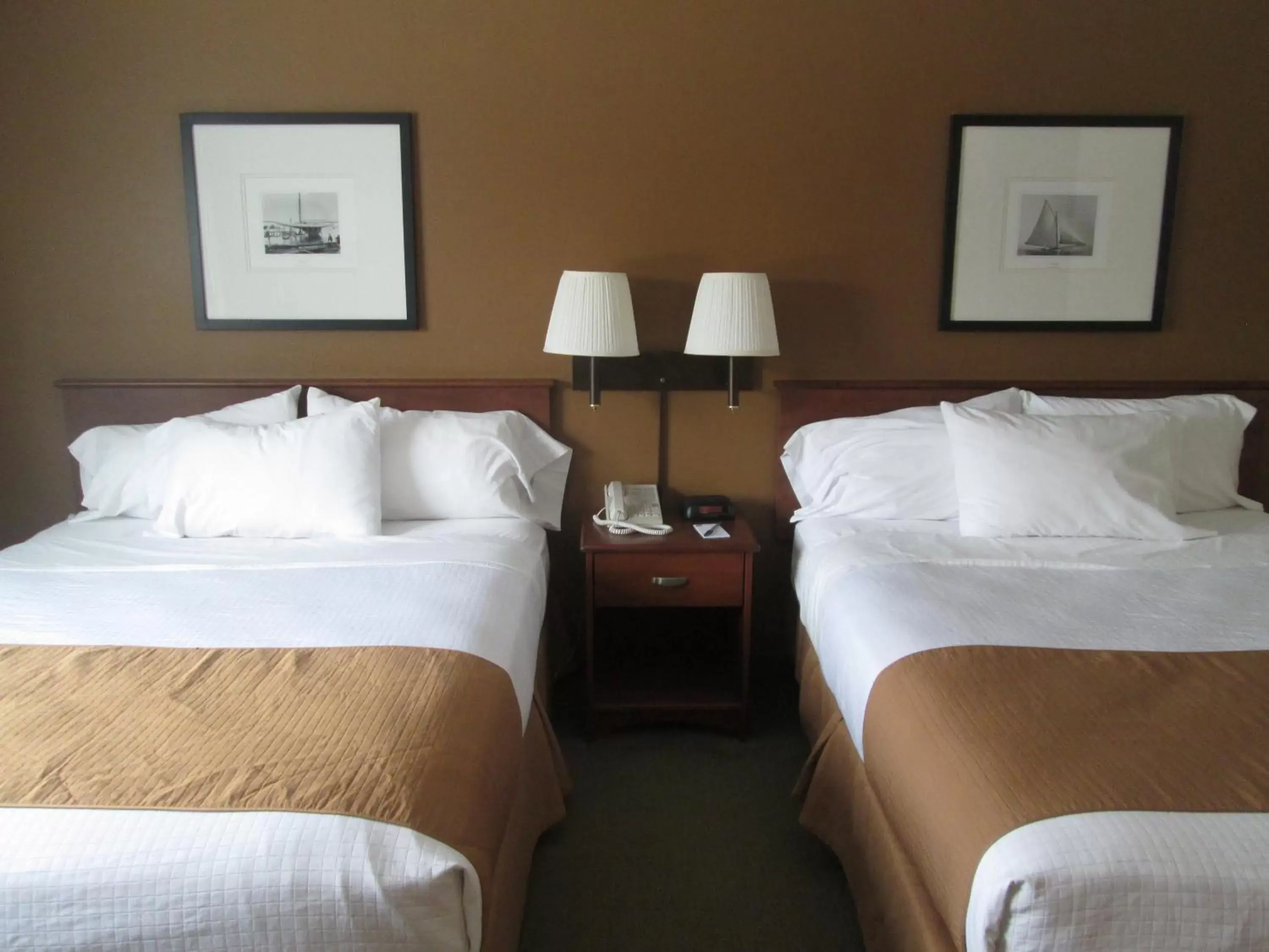 Bed in AmericInn by Wyndham Charlevoix