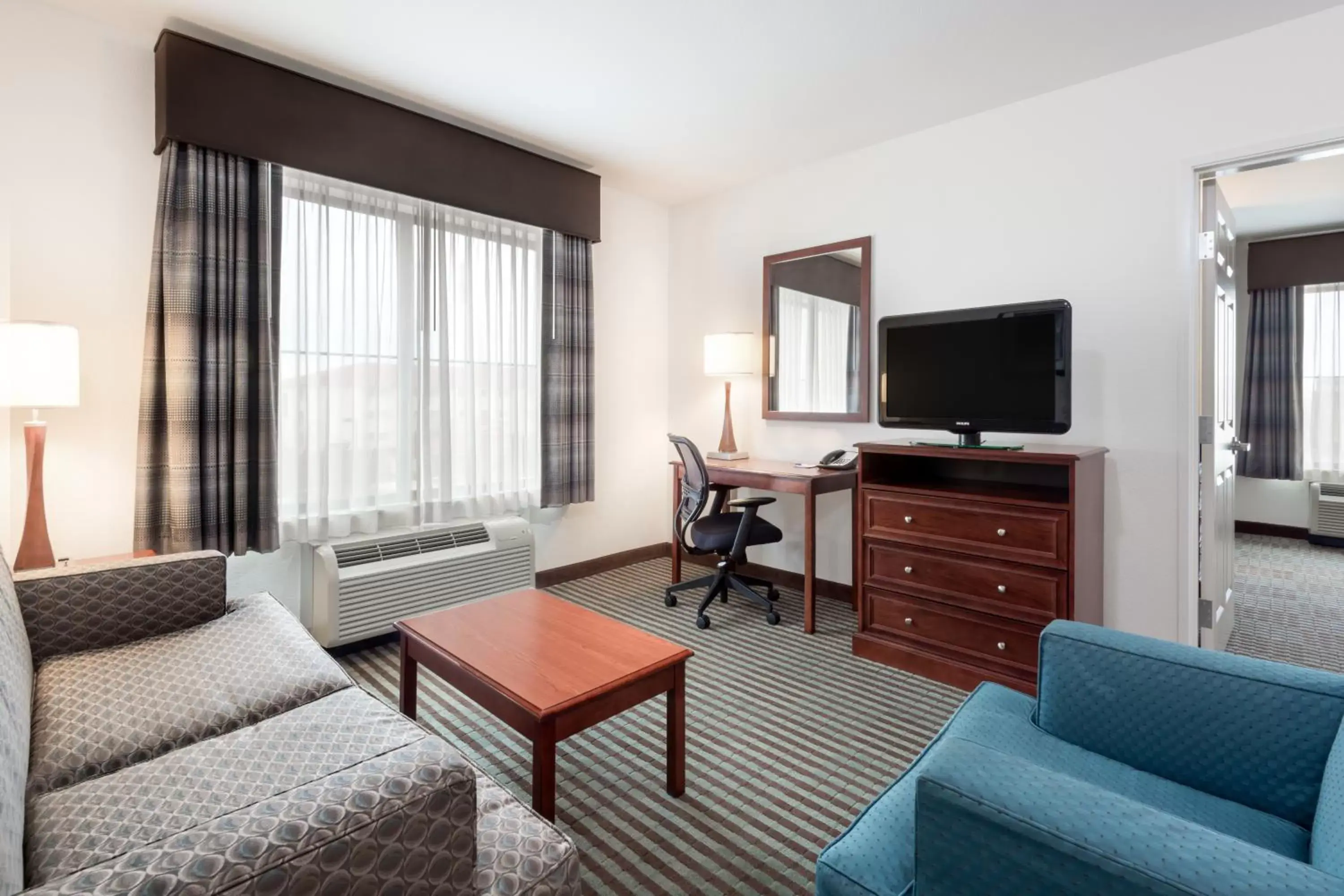 Living room, Seating Area in Baymont by Wyndham Denver International Airport