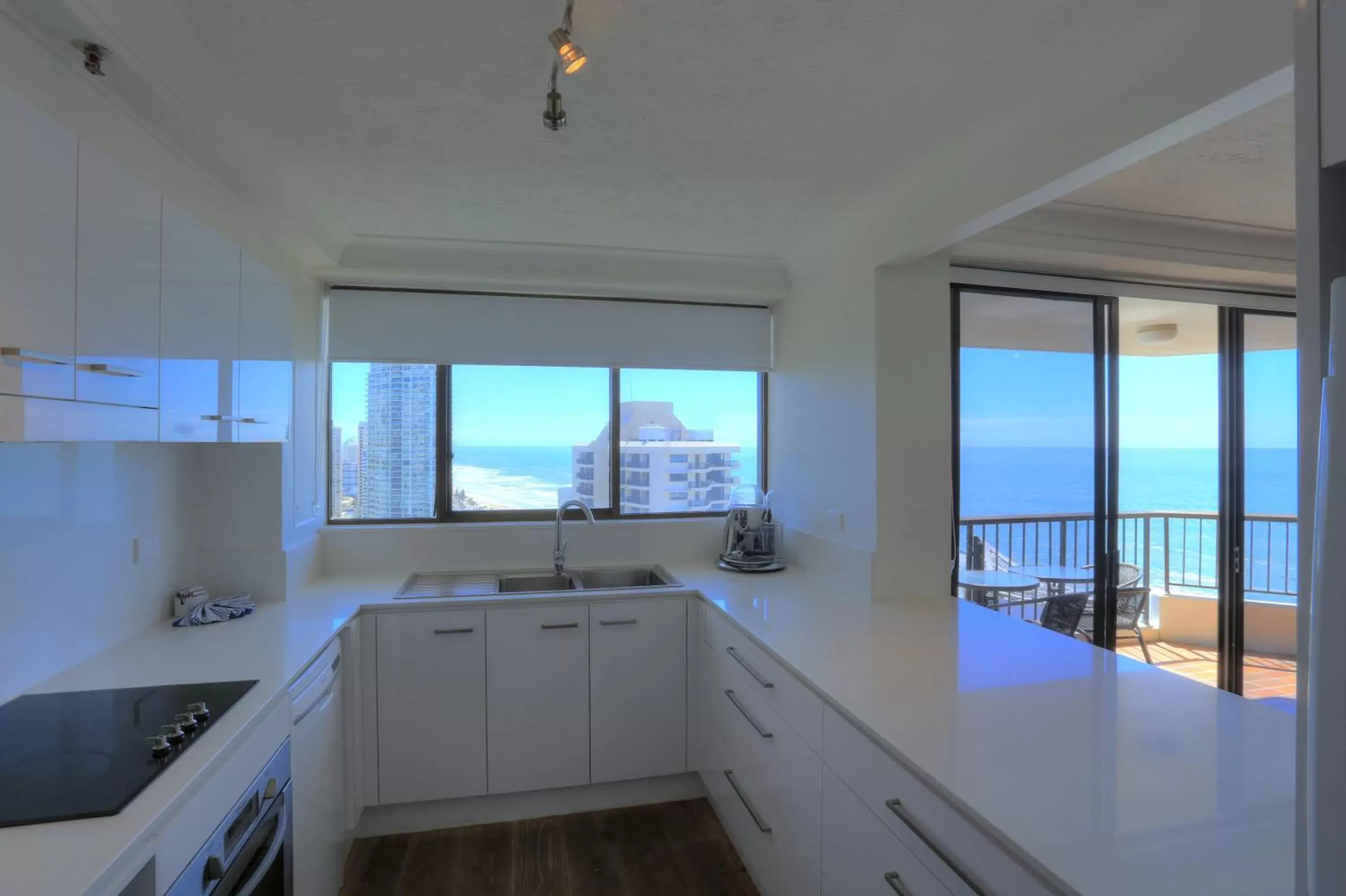 Living room, Kitchen/Kitchenette in Surfers Century Oceanside Apartments