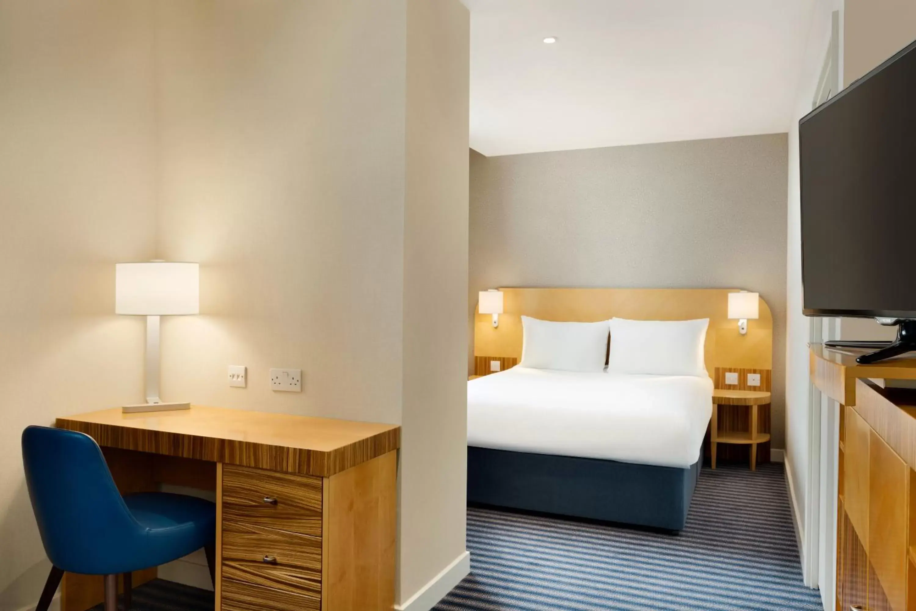 Bed in Ramada Hotel & Suites by Wyndham Coventry