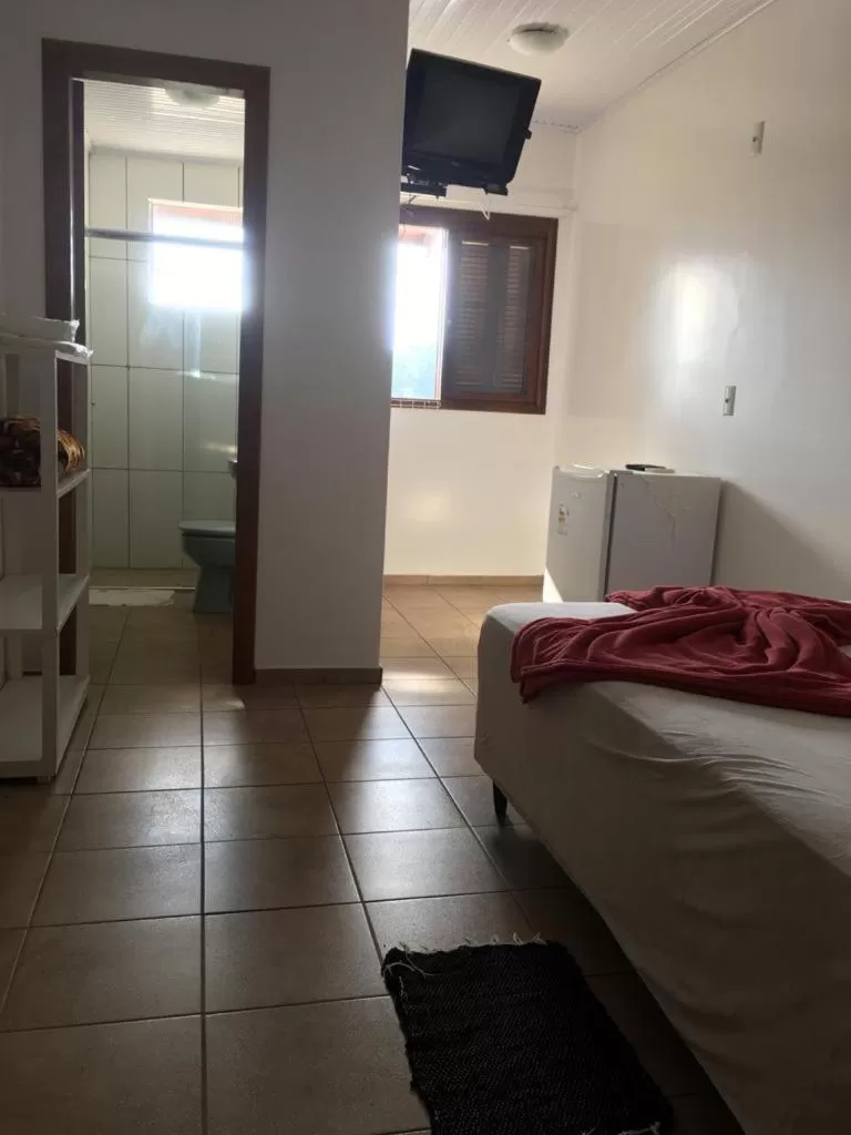 Bed in Hotel Pousada Rolantchê