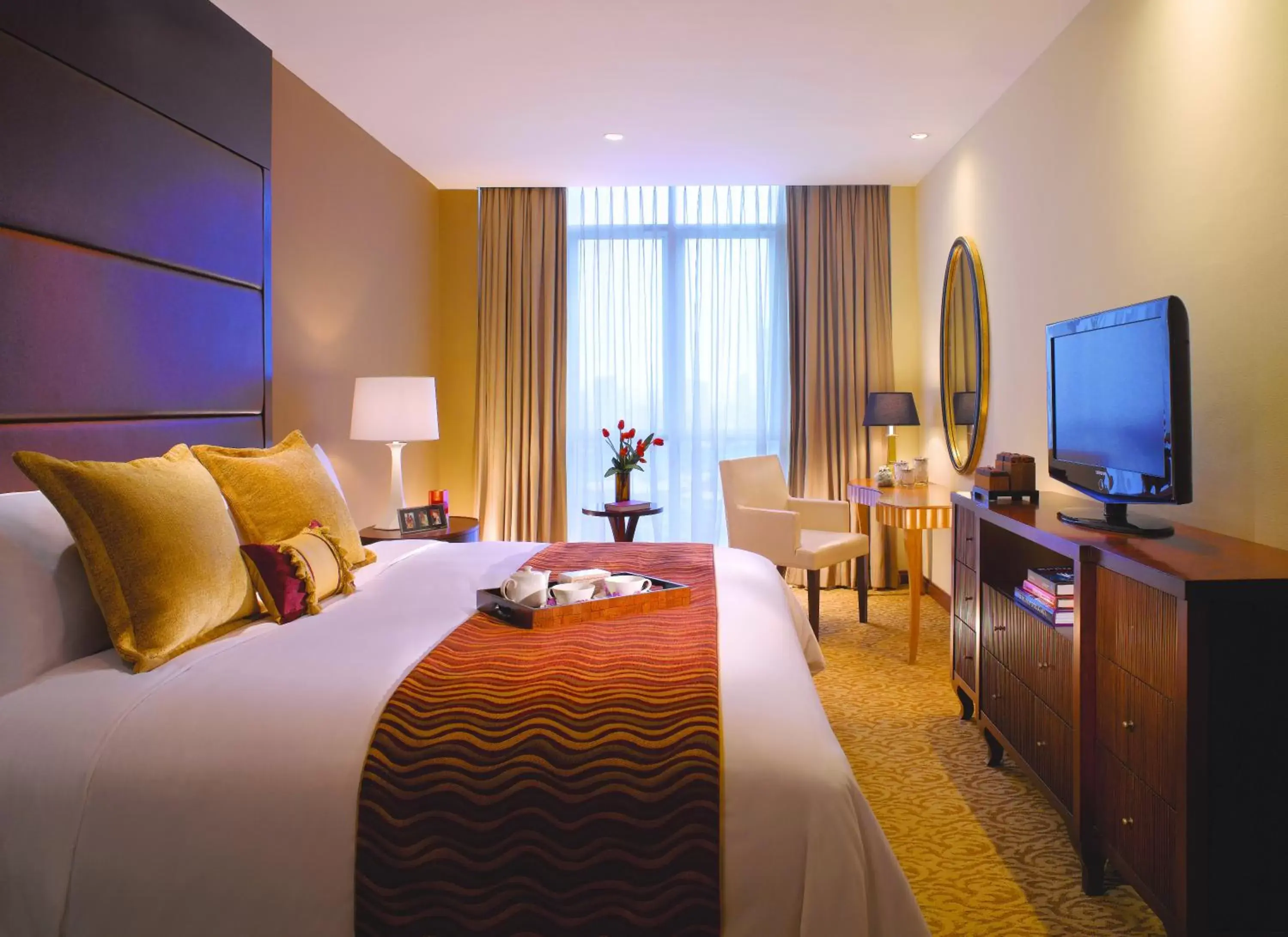 Bed, TV/Entertainment Center in Oakwood Premier Cozmo Jakarta