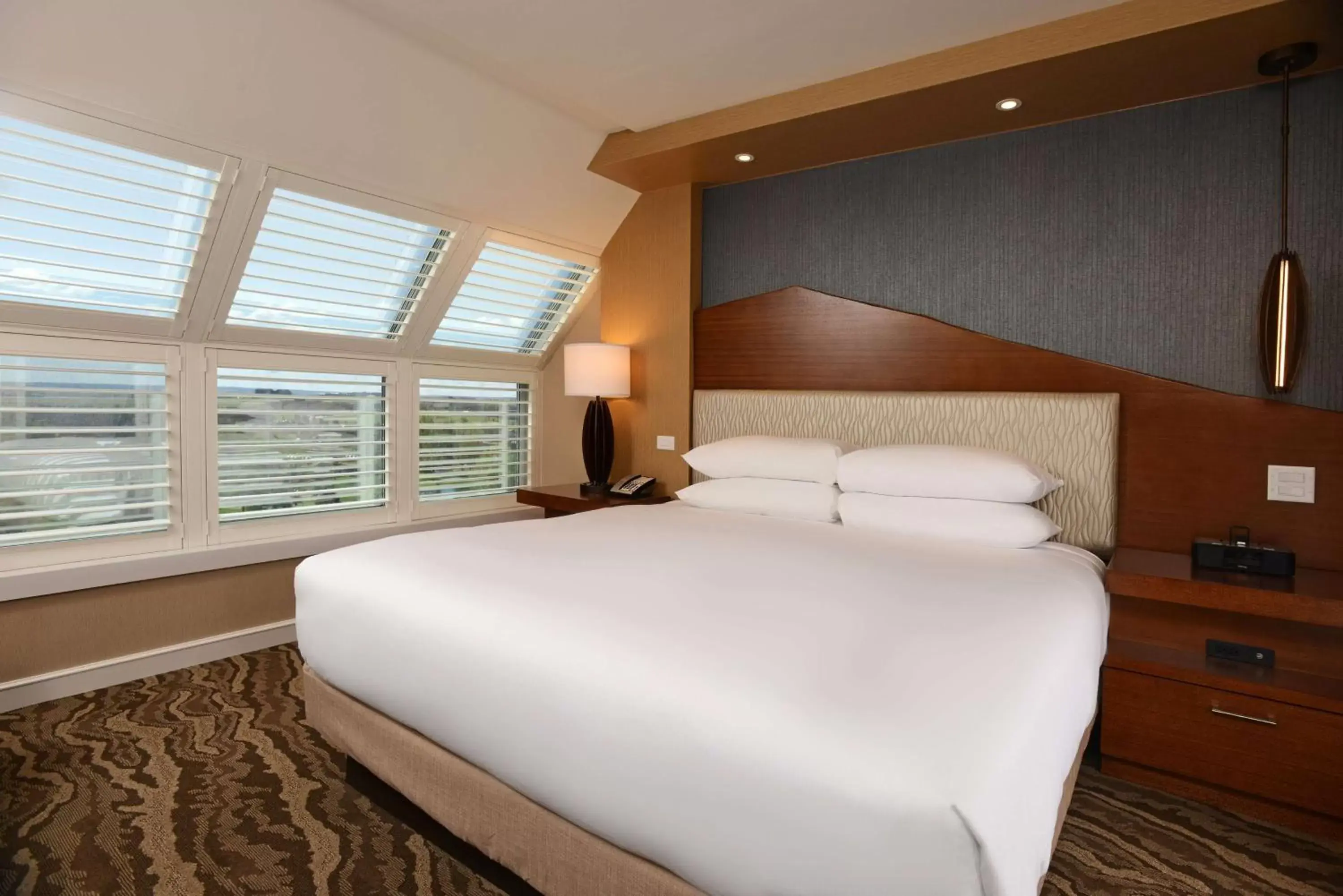 Bed in The Inverness Denver, a Hilton Golf & Spa Resort