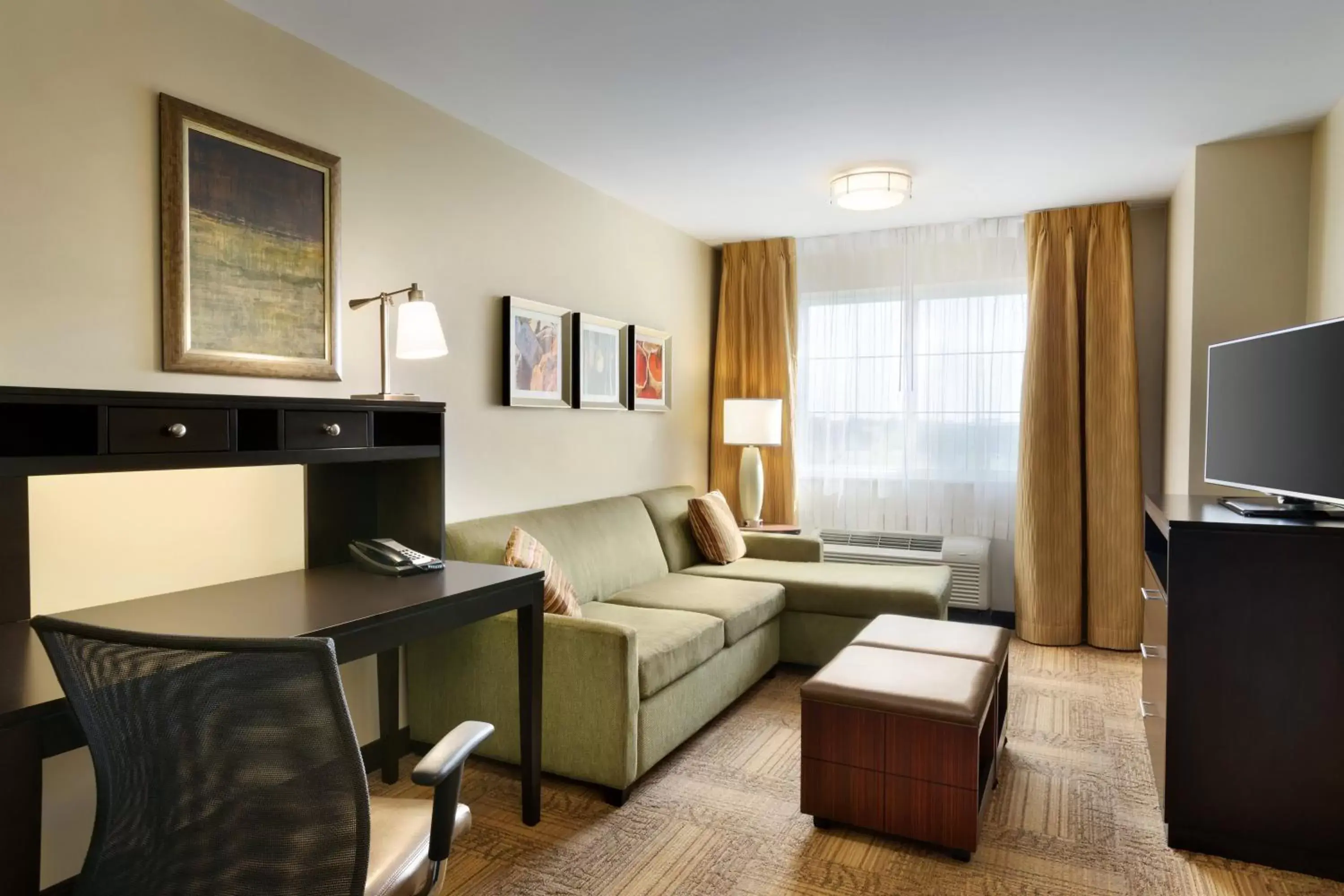 Bedroom, Seating Area in Staybridge Suites West Edmonton, an IHG Hotel