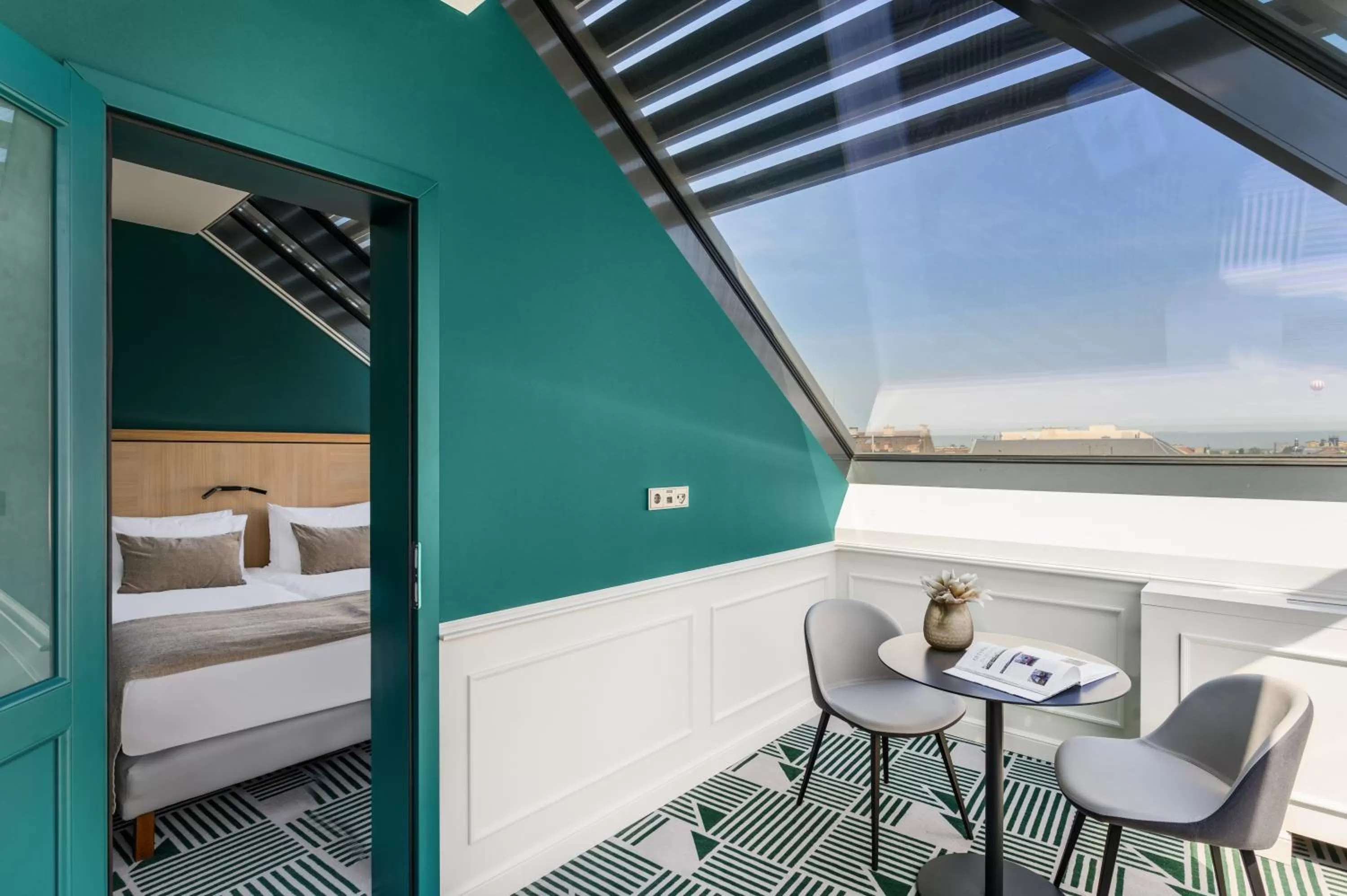 Seating area, Bed in Hotel Oktogon Haggenmacher by Continental Group